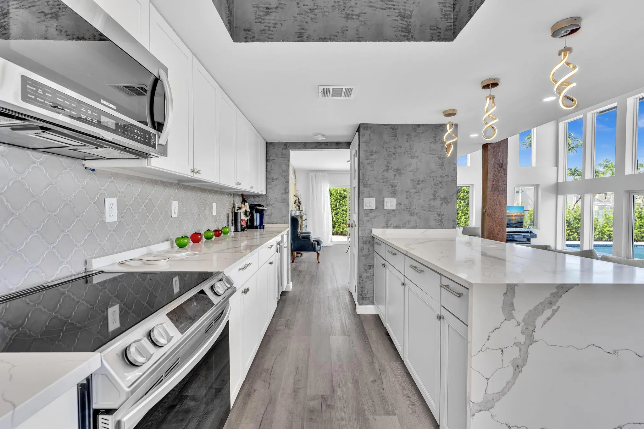 Open concept kitchen with marble counter tops and expansive counter space.