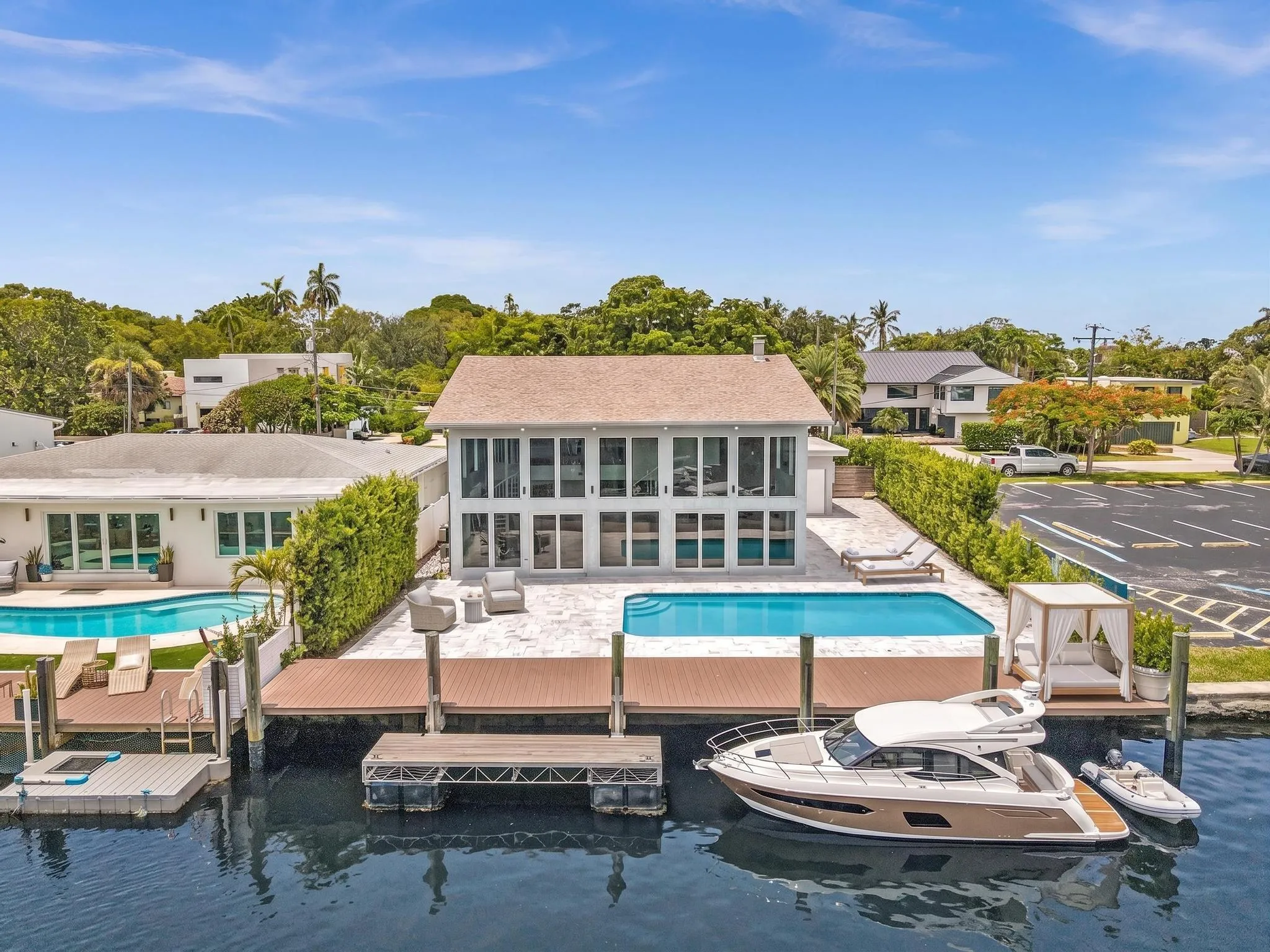 Back of home with vast pool and waterfront access. Virtually Staged