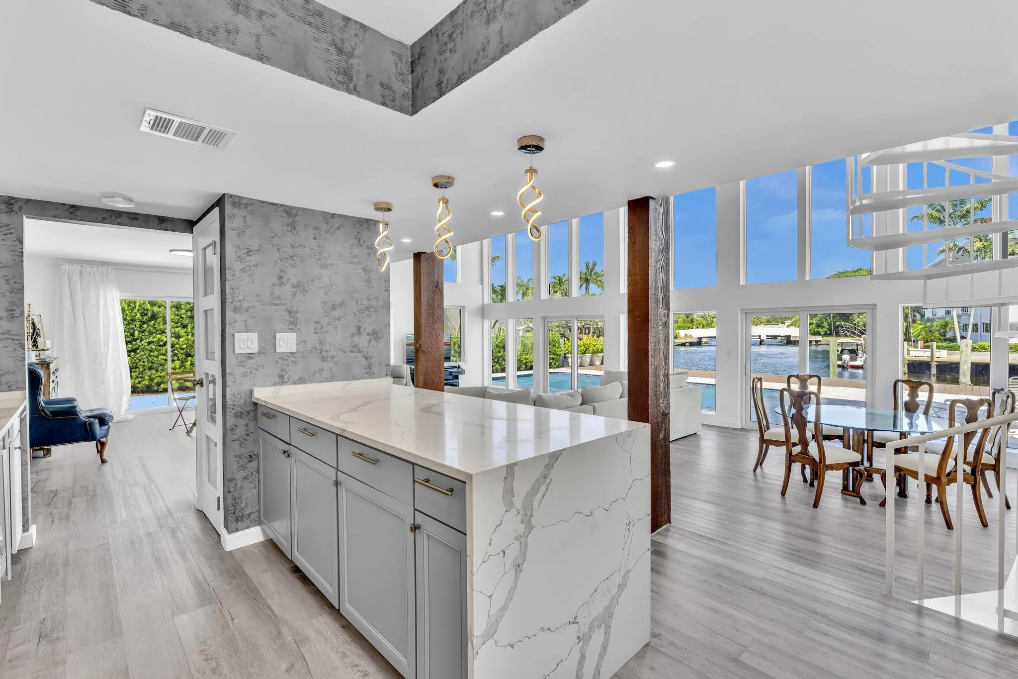 Open concept kitchen with marble counter tops and expansive counter space.