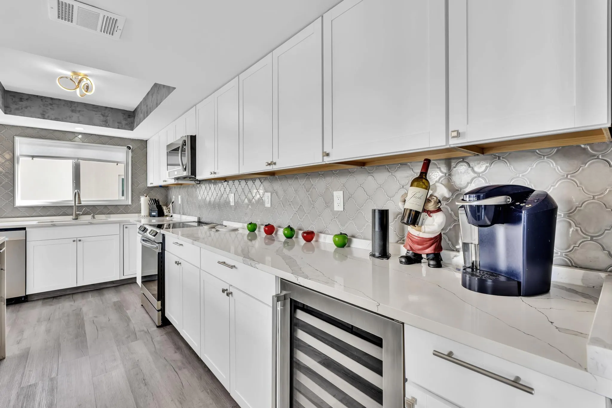 Kitchen Entryway with stainless steel appliances and wine fridge.