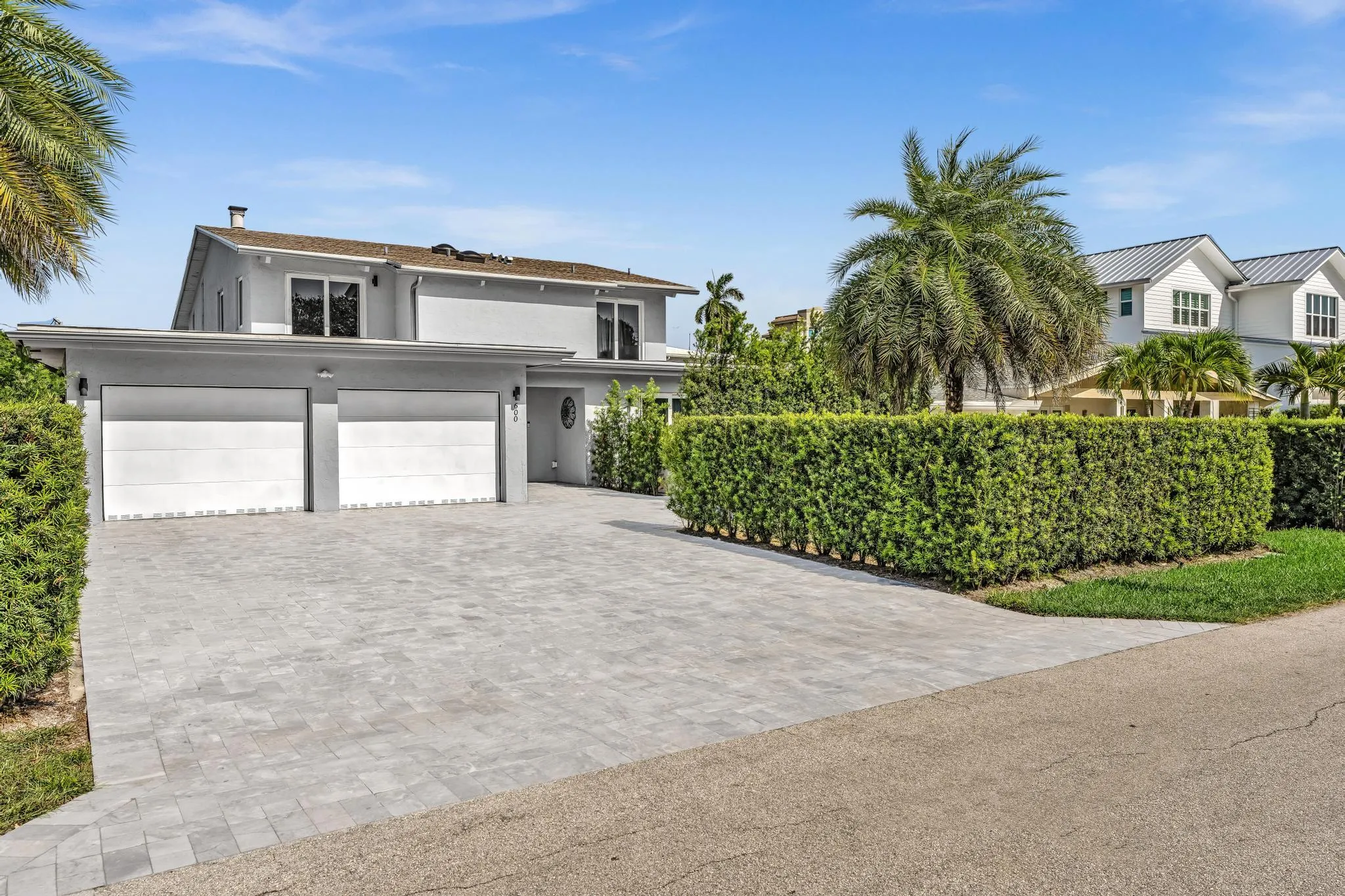 Front of Home with two car garage and paver driveway.