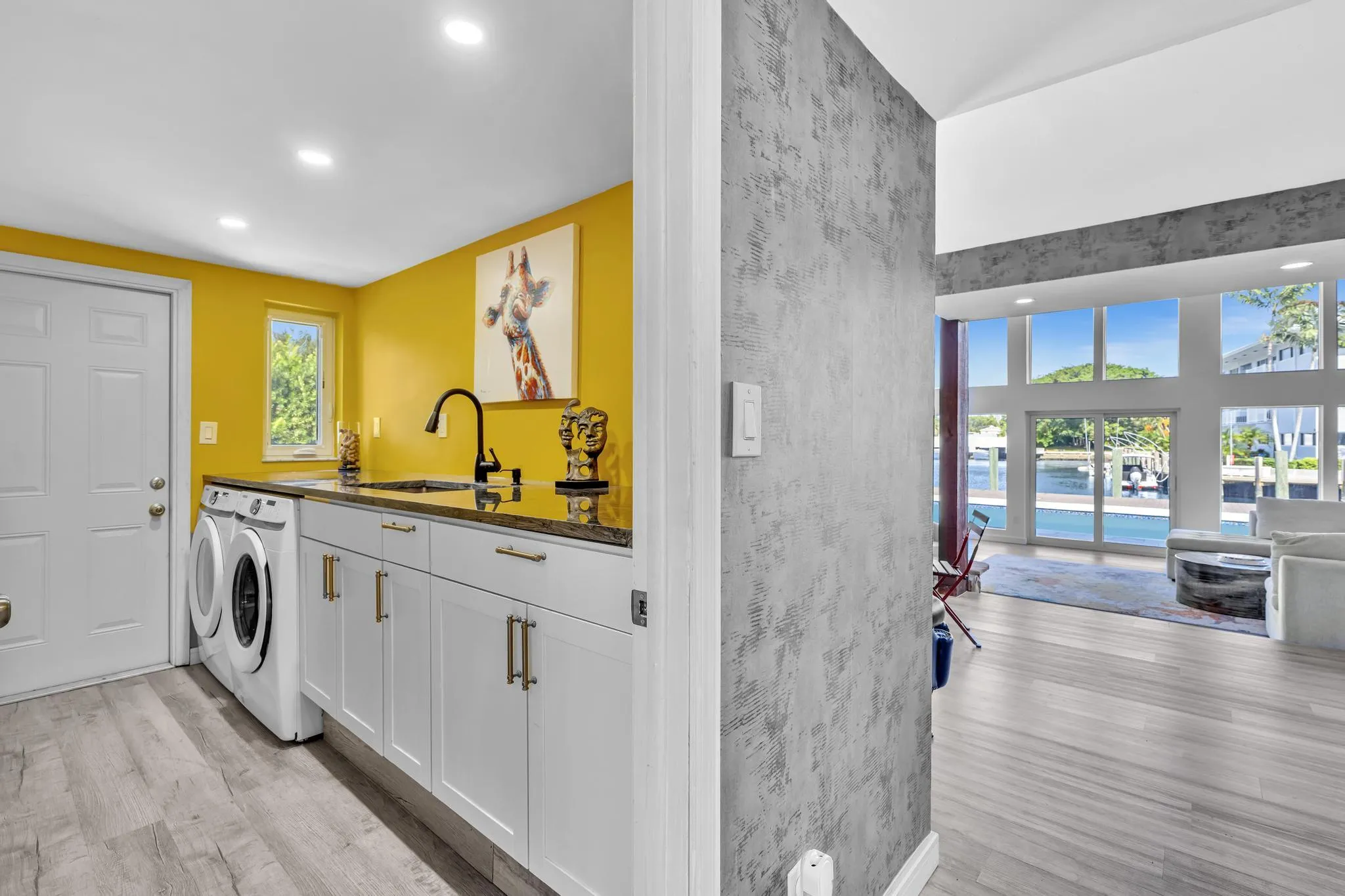 Laundry Room with washer and dryer, built in sink, and garage access