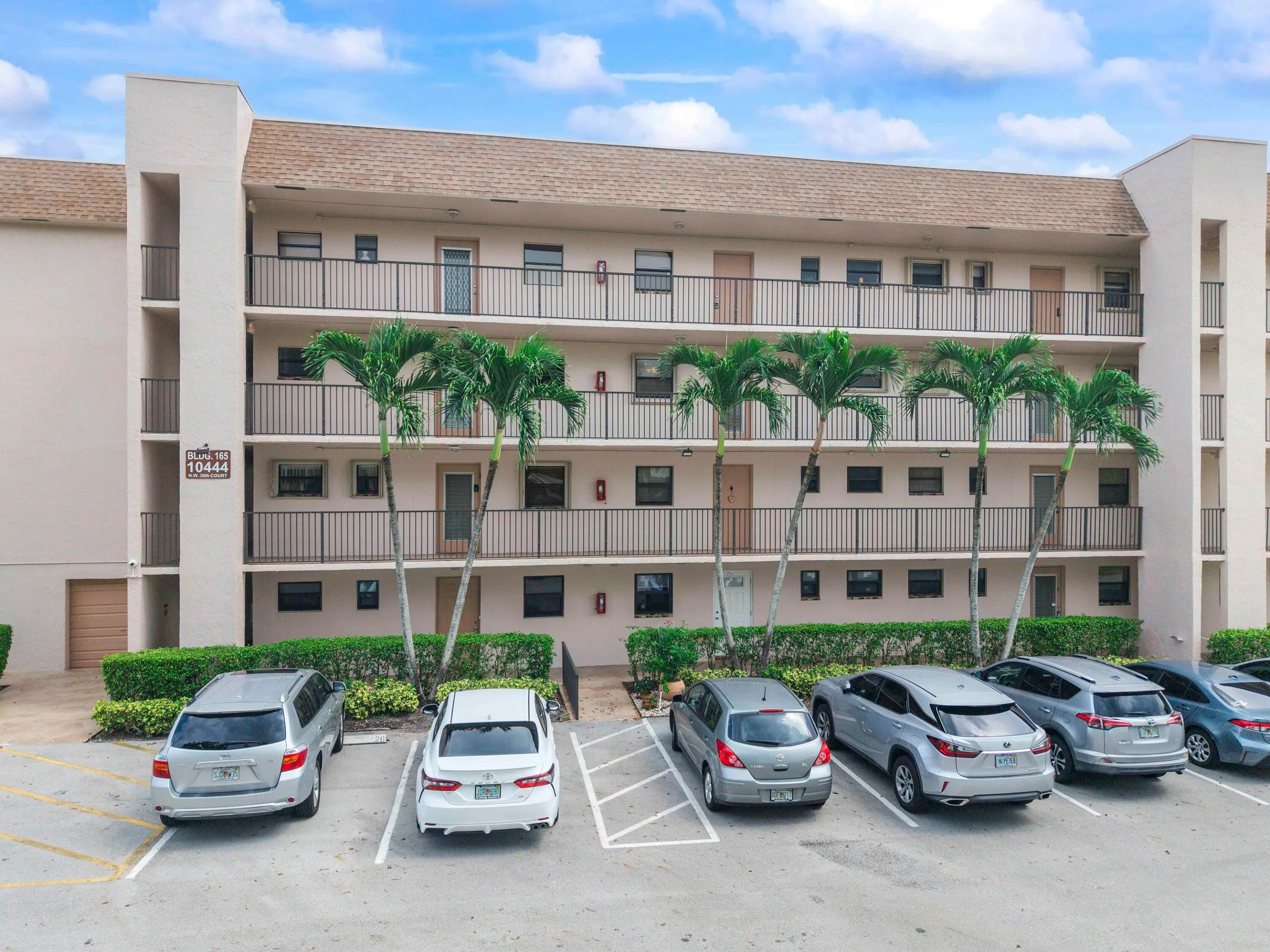 Multi-story residential building with private balconies and black metal railings