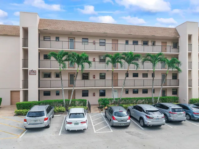 Multi-story residential building with private balconies and black metal railings