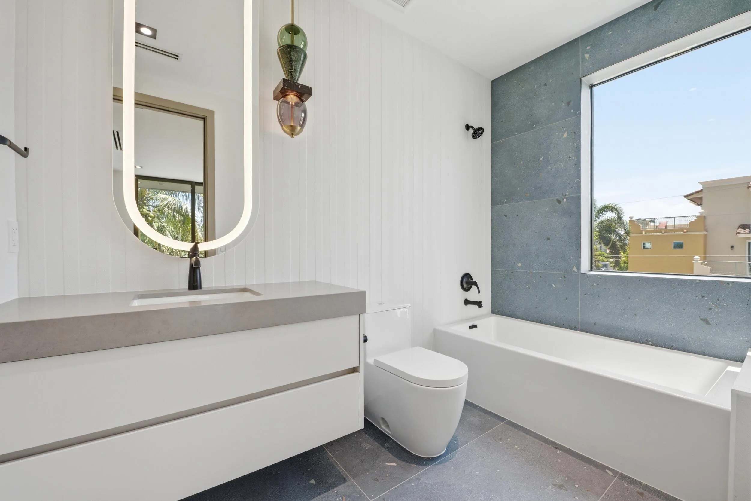 Floating vanity with an integrated sink and matte black faucet