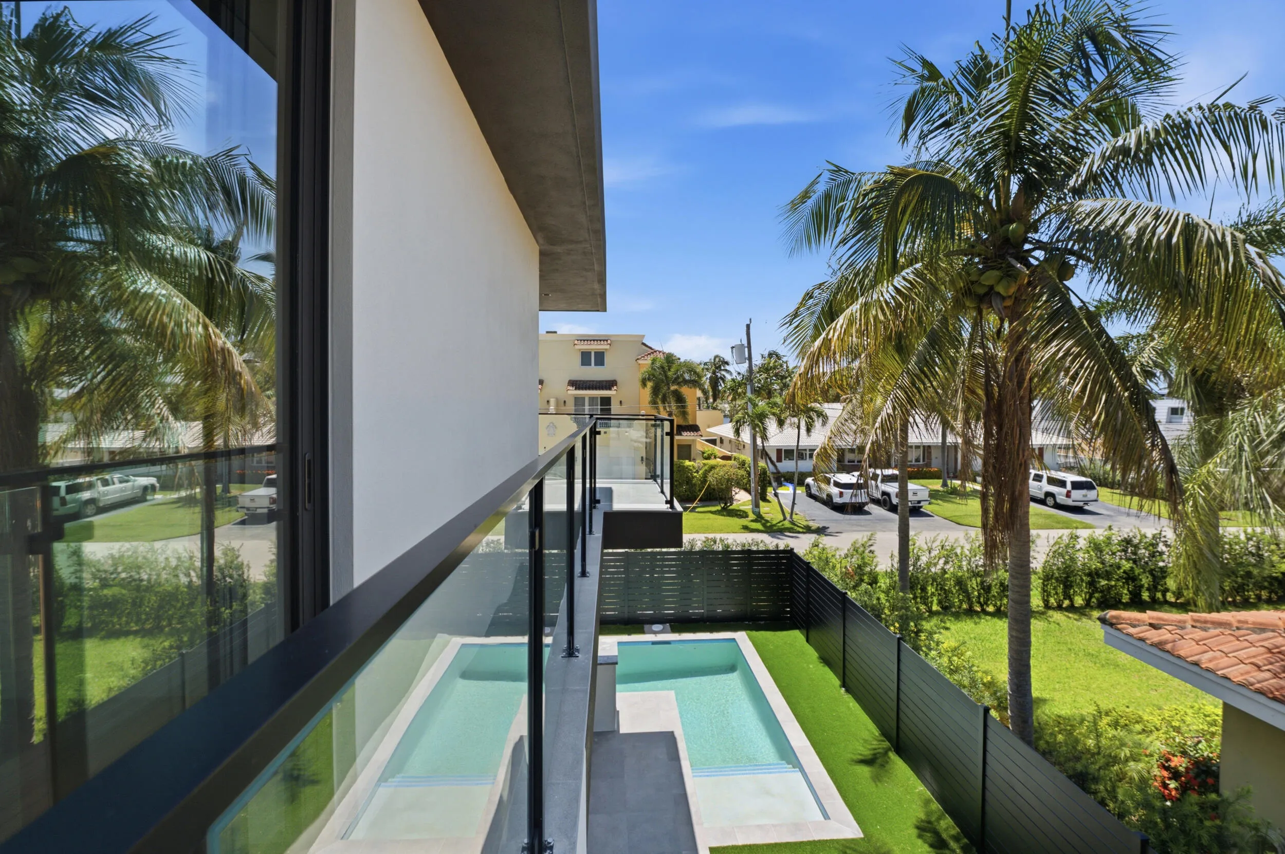Balcony featuring a glass railing system and tile flooring