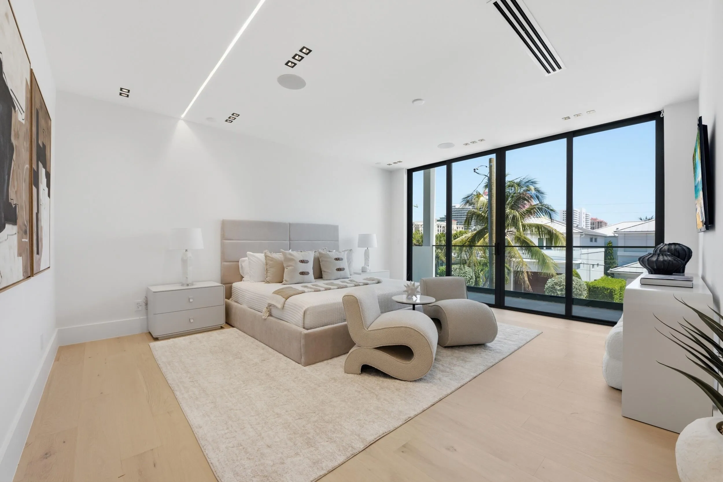 Full-height windows, recessed lighting, wood-finish flooring, and integrated ceiling speakers