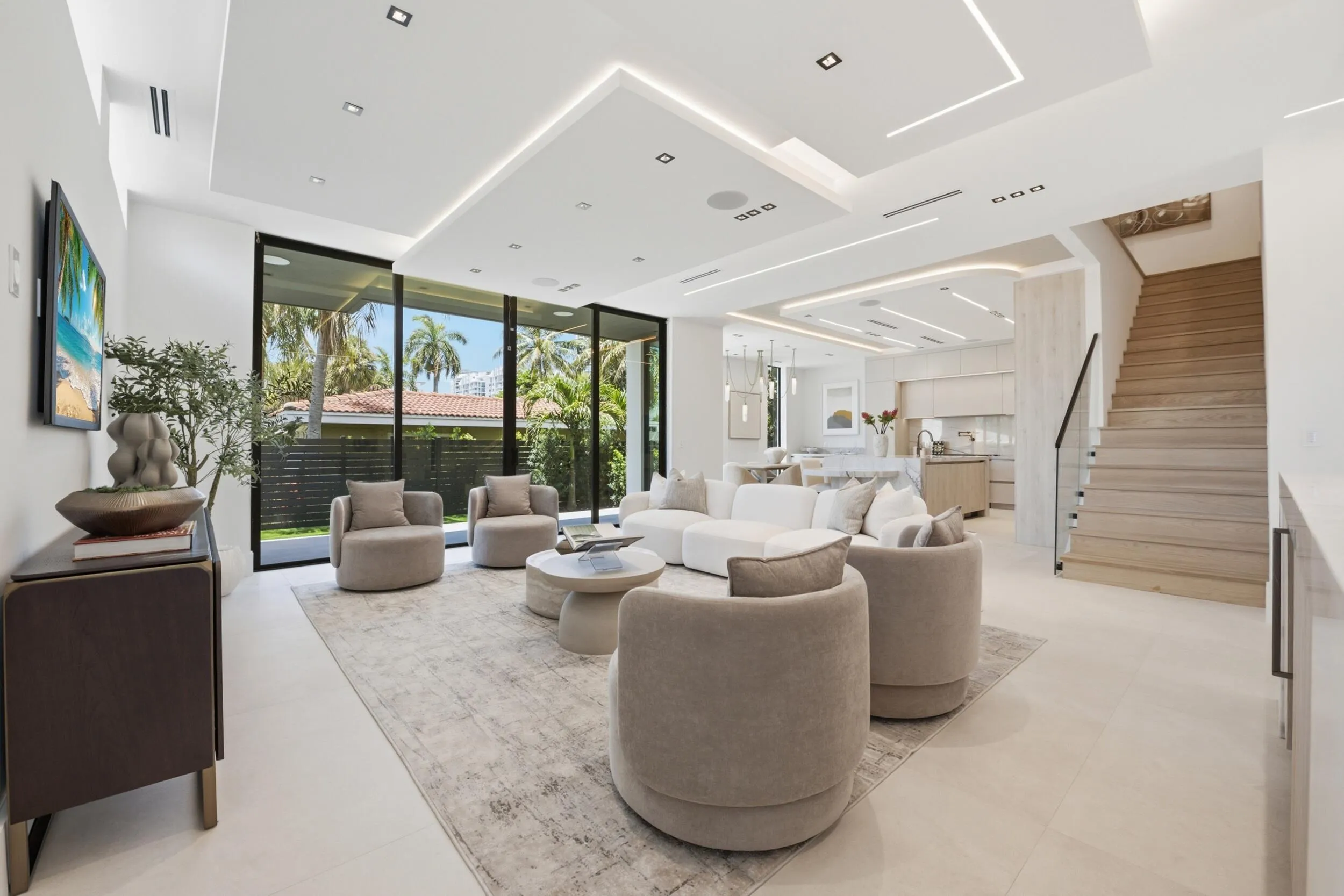 Recessed lighting and linear ceiling accents, large format tile flooring, and a modern open staircase with glass paneling