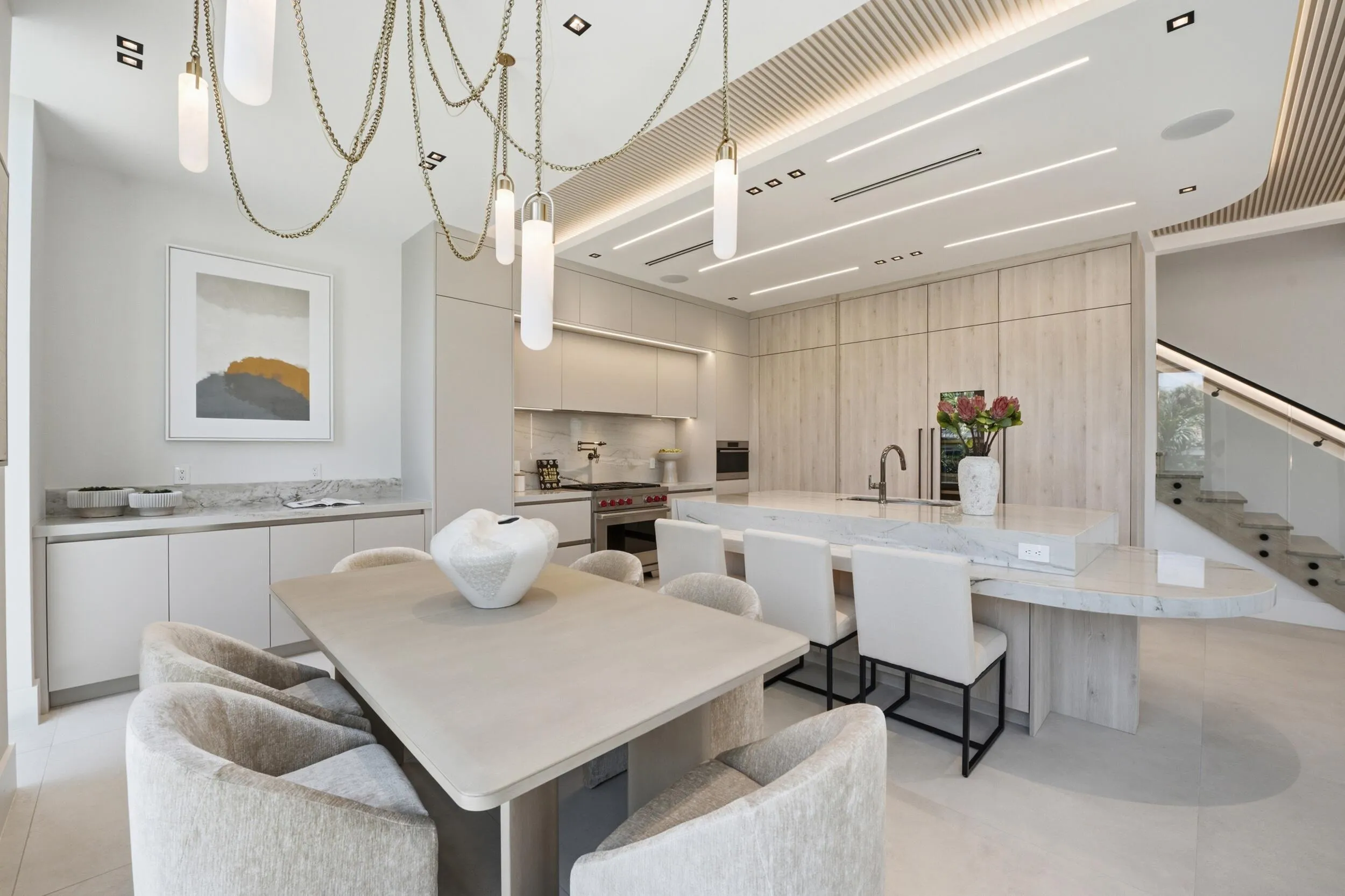Gourmet kitchen with integrated appliances, extensive stone countertops, and a waterfall island