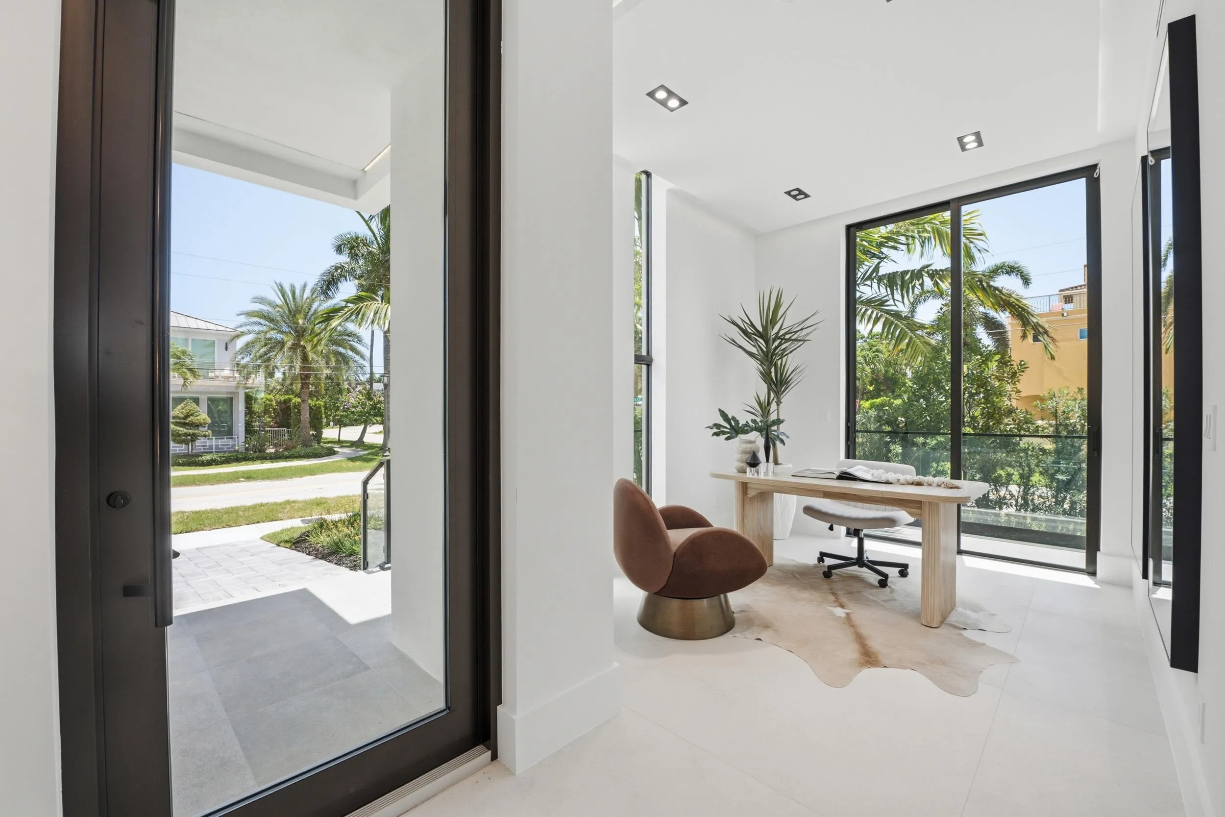 White-finished walls with recessed lighting, large windows, and white flooring