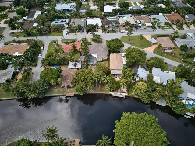 Elevated view showcases the property’s position along the water within an established residential neighborhood.
