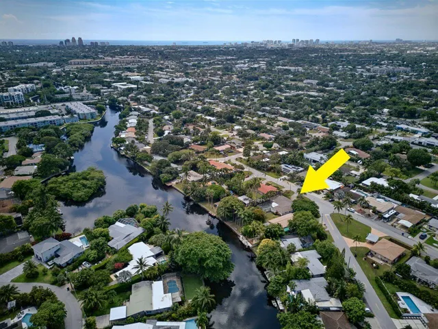 Expansive aerial perspective highlights the property’s position near the water and its established tropical surroundings.