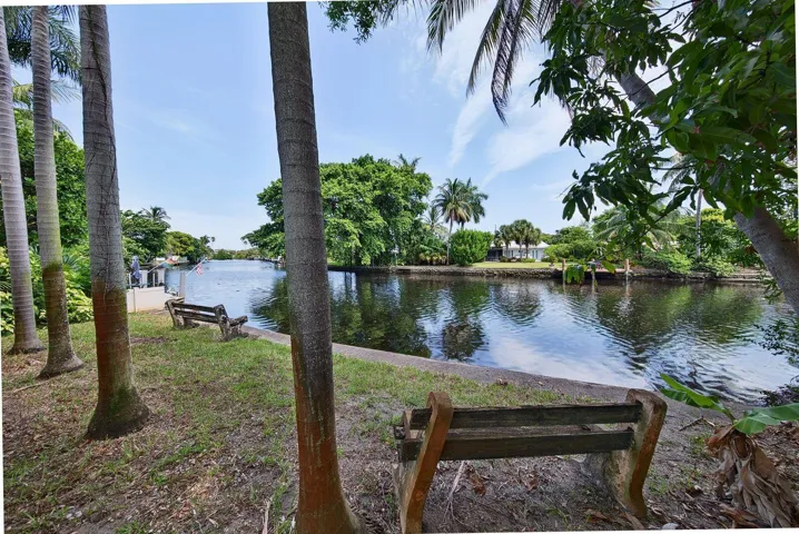 Peaceful canal views framed by mature tropical landscaping create a private South Florida setting.