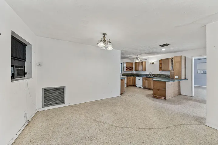Open dining and kitchen arrangement offers flexibility for renovation and contemporary redesign.