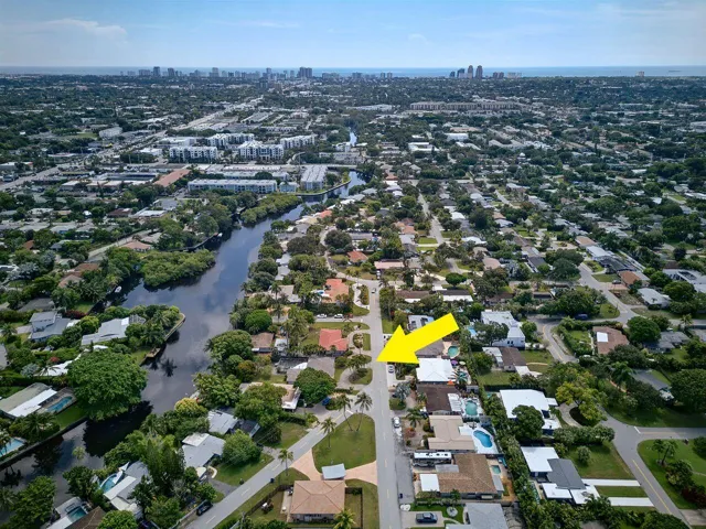 Aerial view identifies the property within its waterfront neighborhood, with the Atlantic Ocean and coastal skyline visible in the distance.