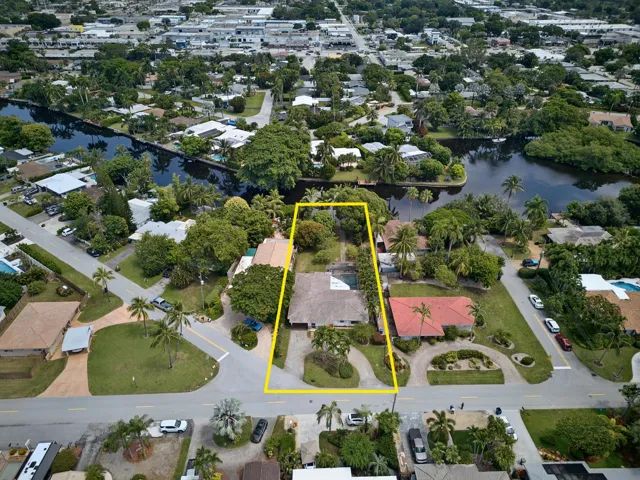 Aerial view highlights the property’s substantial lot, waterfront setting and excellent renovation or redevelopment potential.