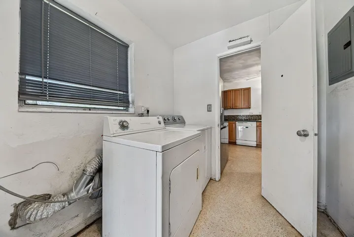 Dedicated laundry area with full-size washer and dryer, conveniently located adjacent to the kitchen.