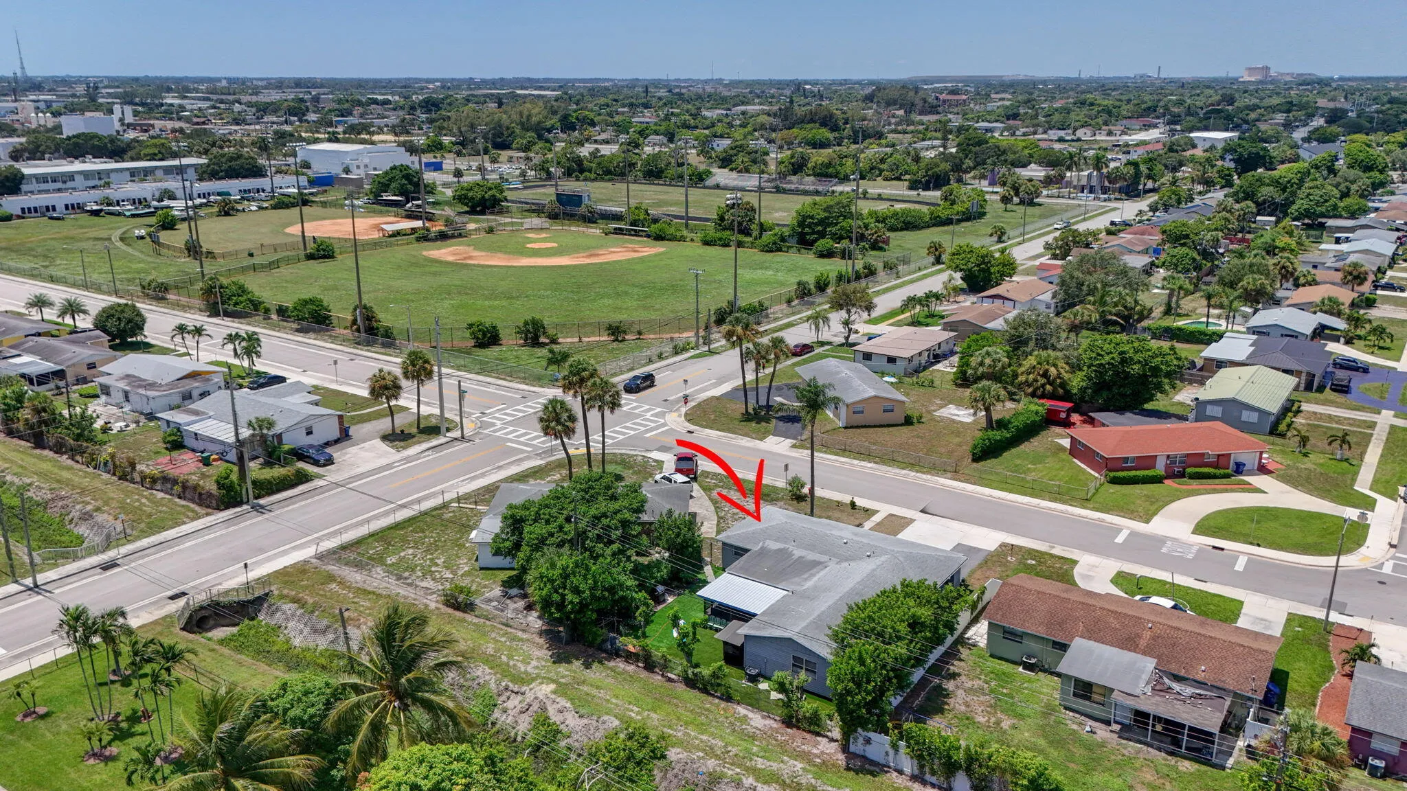 Aerial perspective showcasing the residential area with established landscaping and a nearby recreational field