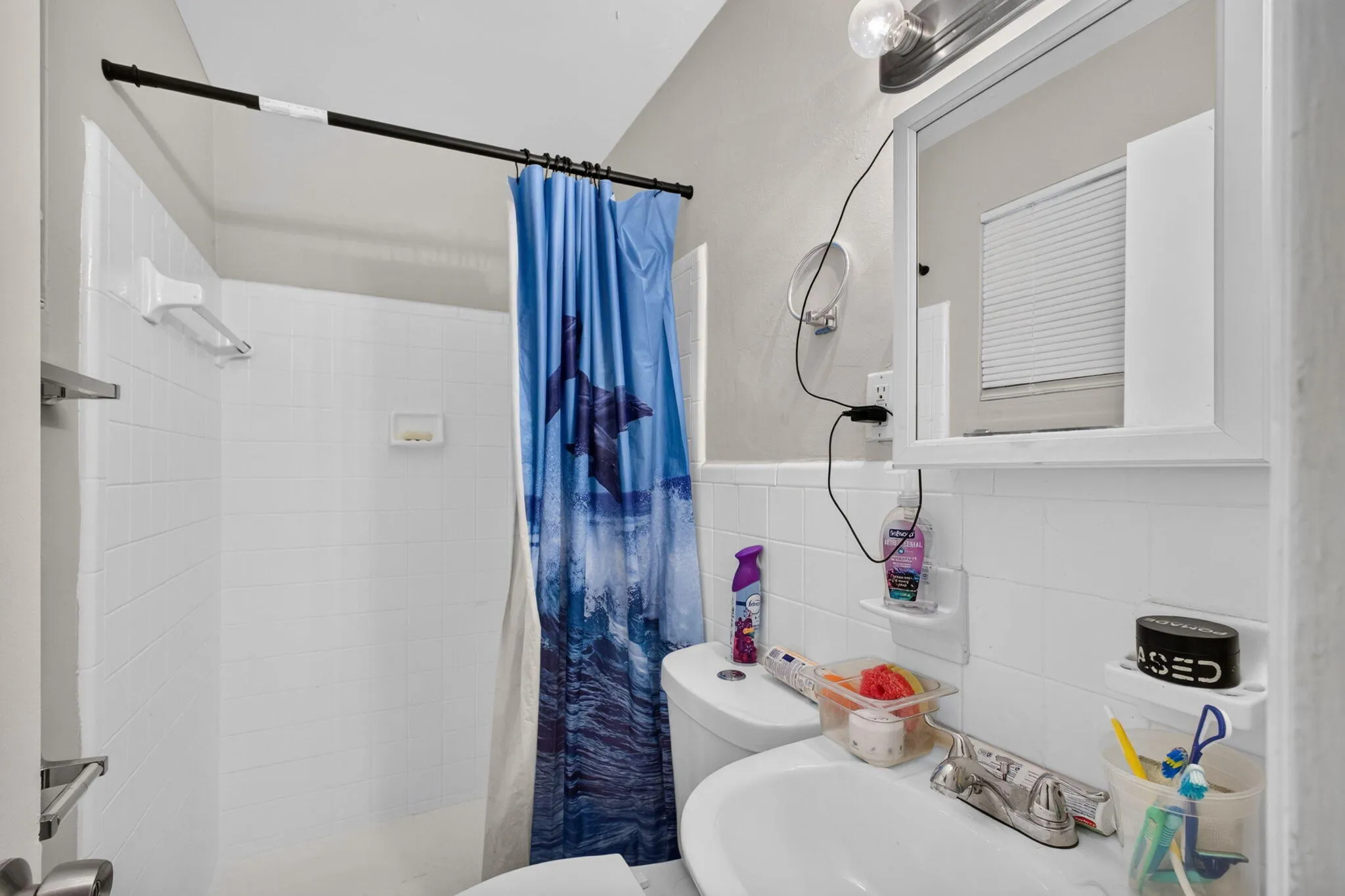 White subway tile shower surround with a built-in soap dish