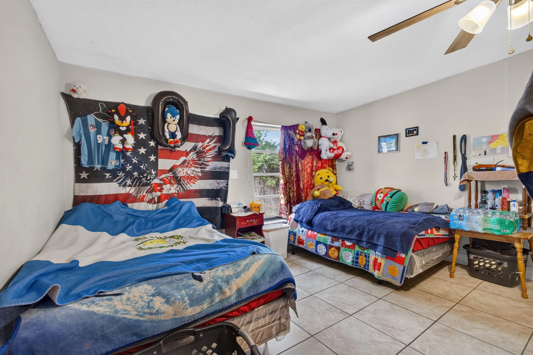 Tile flooring throughout with a ceiling fan and natural light