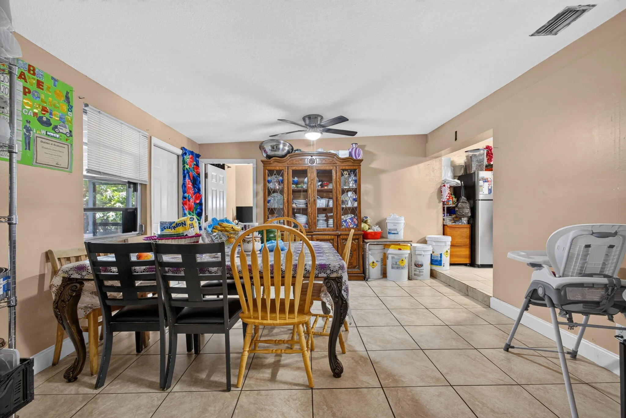 Tile flooring throughout with a ceiling fan overhead