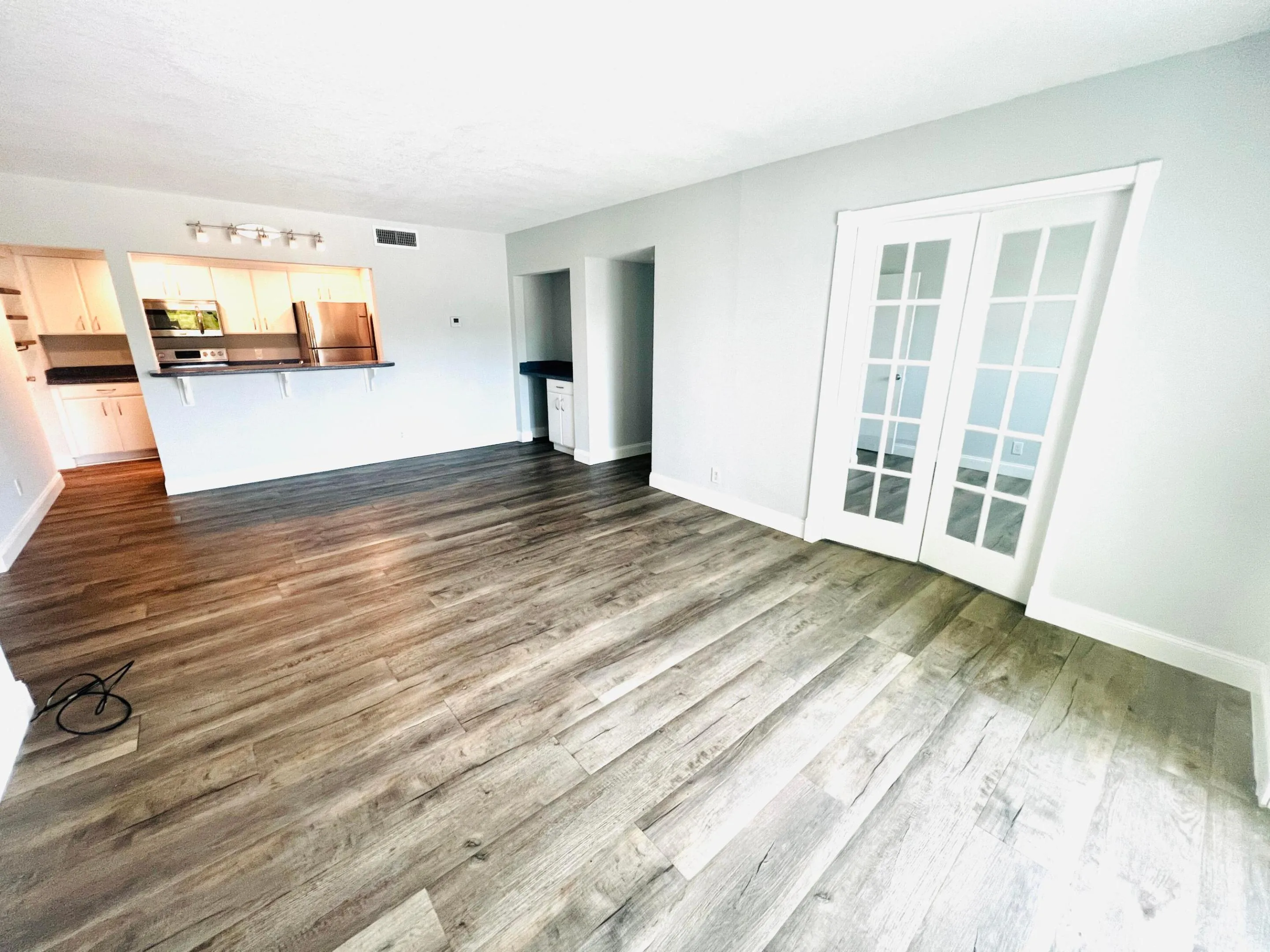 Open Plan Living-Dining room area to Den with French doors