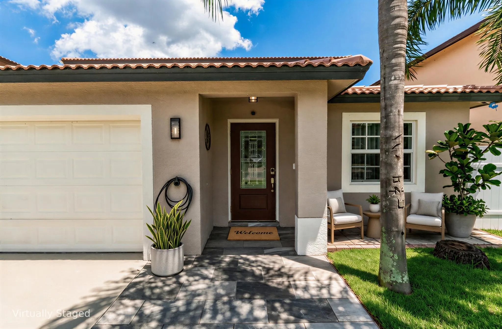 Mediterranean-style exterior with a terracotta tile roof, stucco finish, and a rich wood-tone entry door with glass inserts