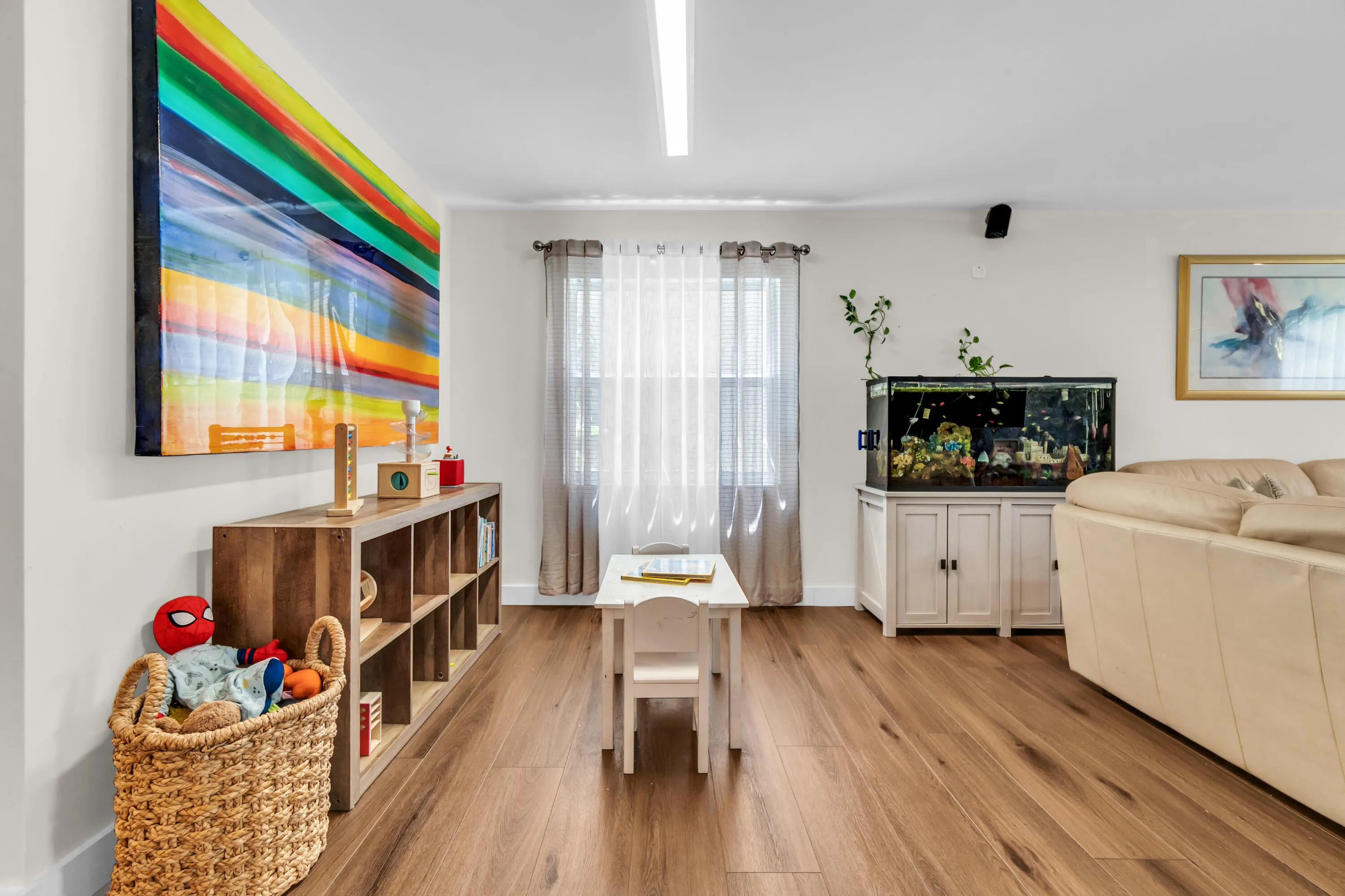 Wood-finish flooring throughout, bright white walls, and a recessed ceiling light fixture