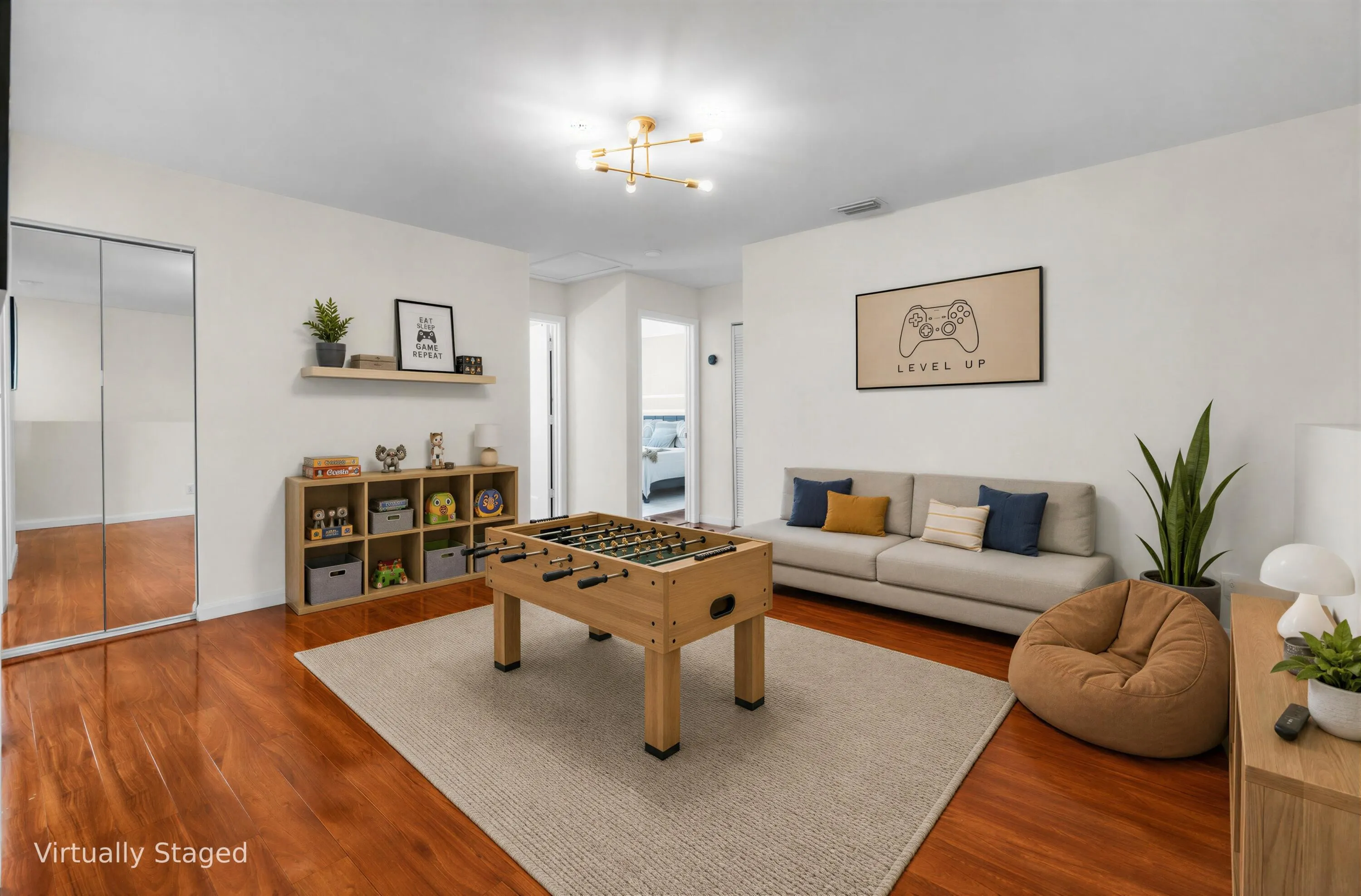 Wood-finish flooring, mirrored sliding closet doors, wall-mounted shelving, and a modern ceiling light fixture