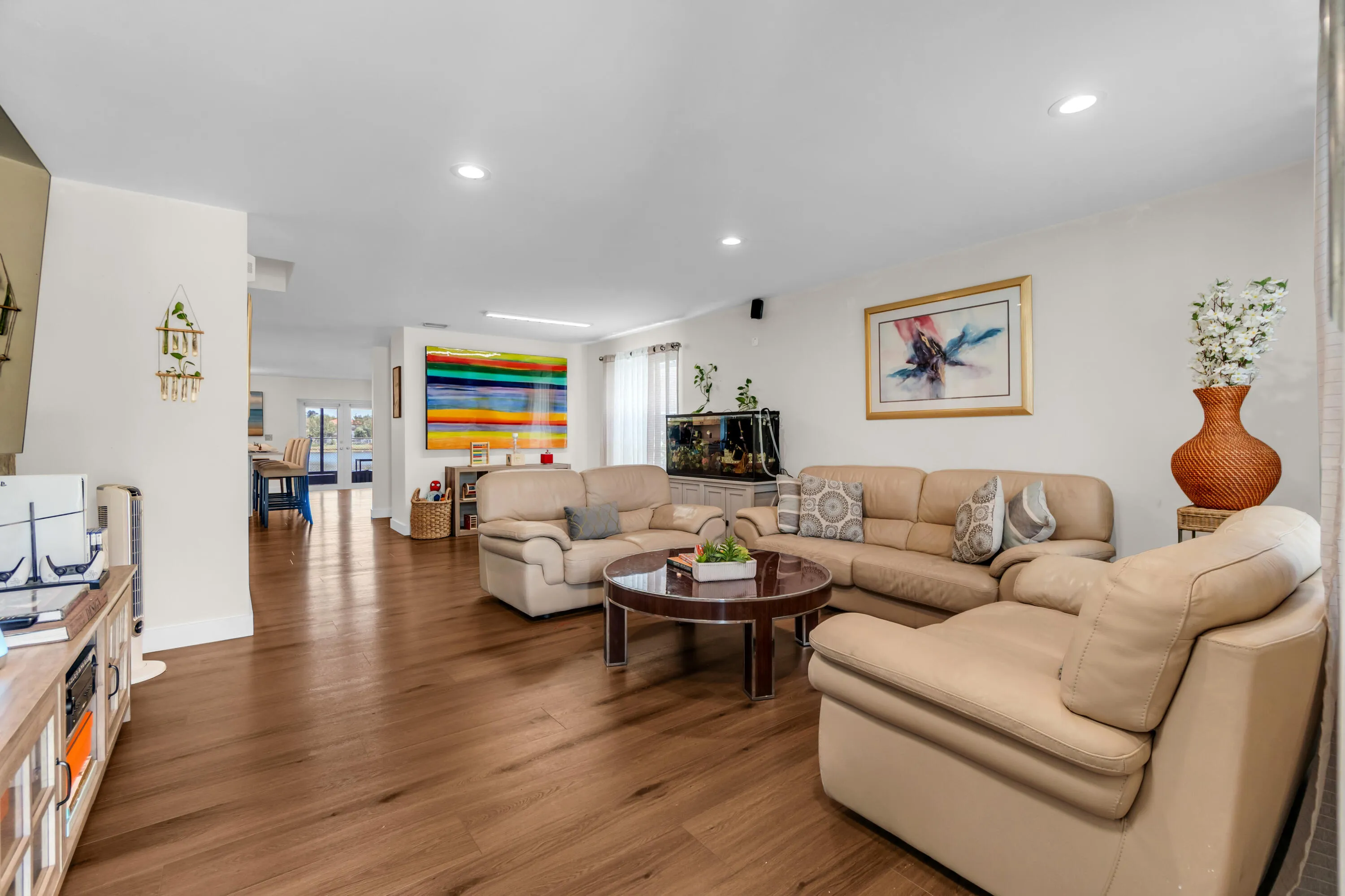 Wood-finish flooring throughout, recessed lighting, and white wall finishes