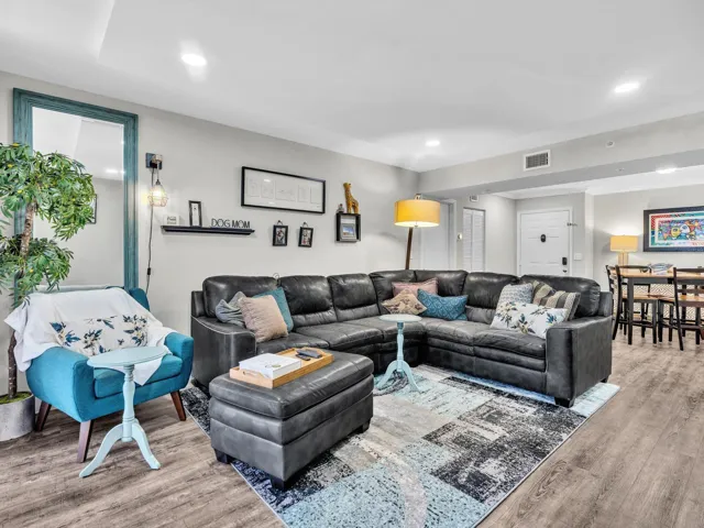 Recessed ceiling lighting, wood-finish flooring, and a dining area with a built-in light fixture