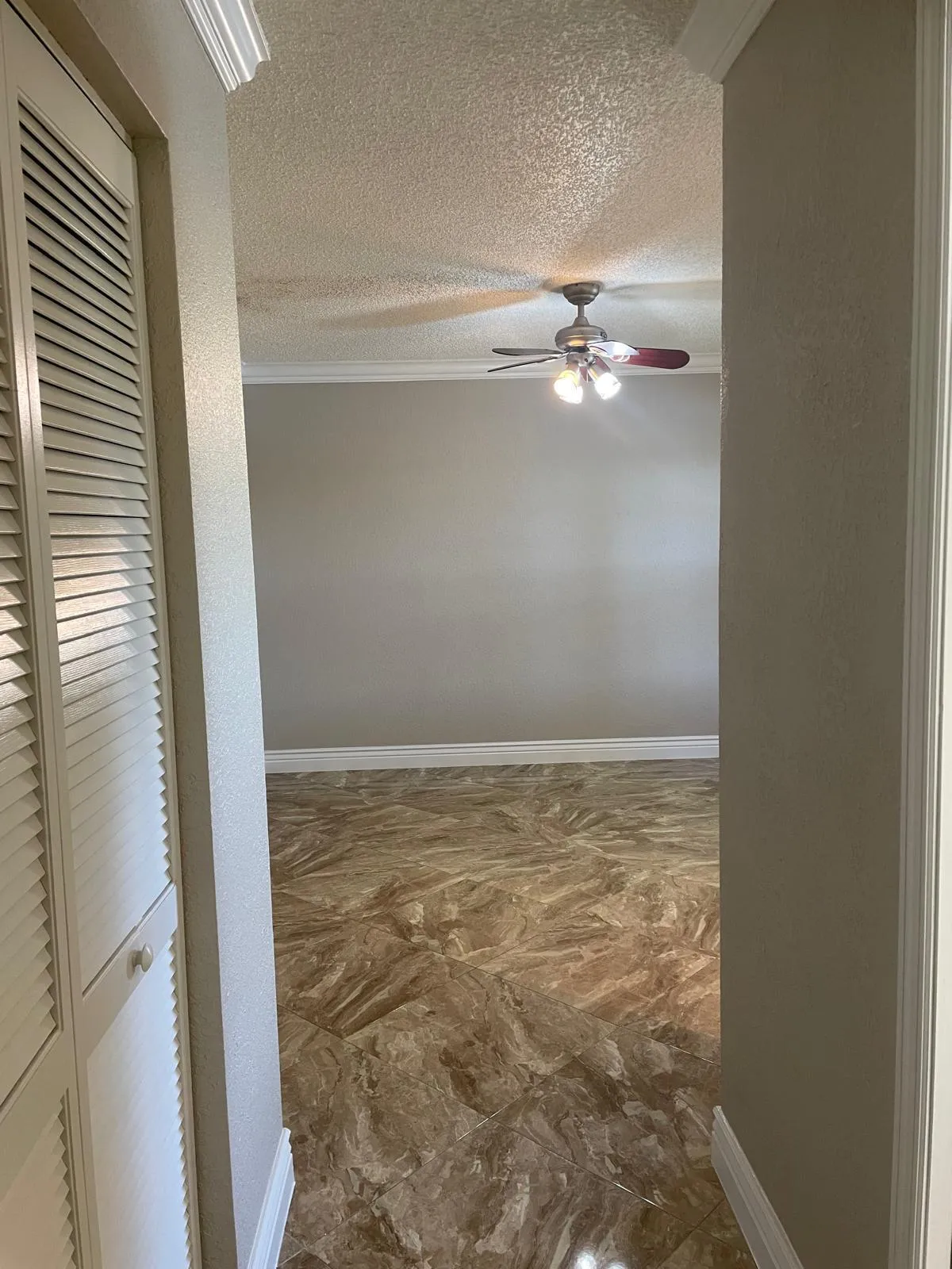 Spacious bedroom with ceiling fan and recessed lighting
