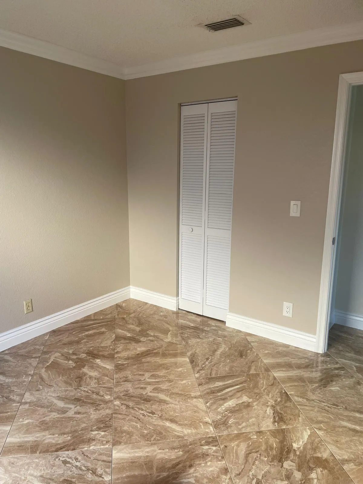Neutral-toned walls complemented by crown molding and white trim