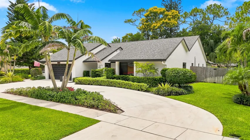 Additional front view highlighting the manicured lawn, mature landscaping, and inviting curb appeal.