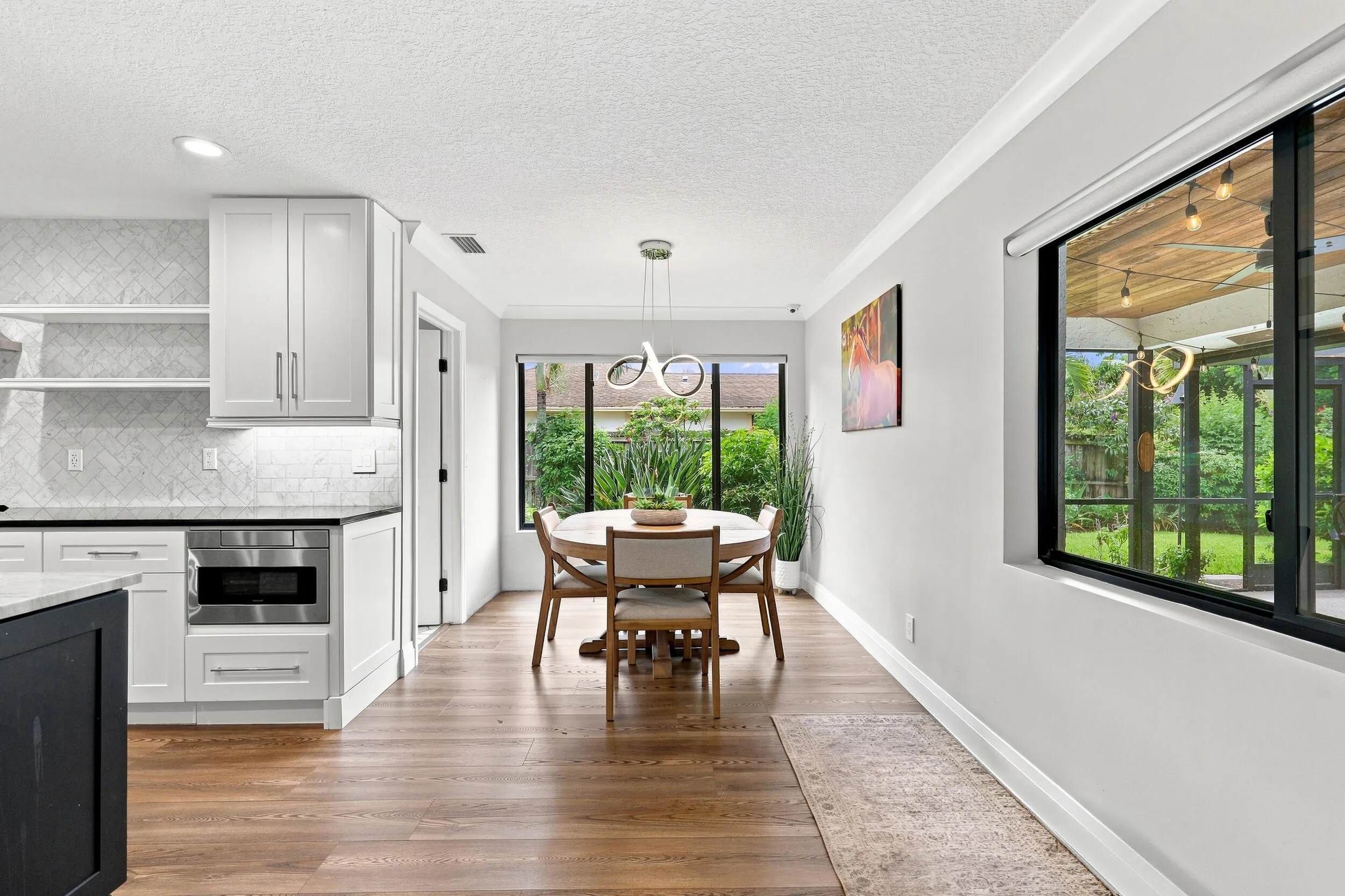 Light-filled dining area conveniently located just off the kitchen with beautiful backyard views.
