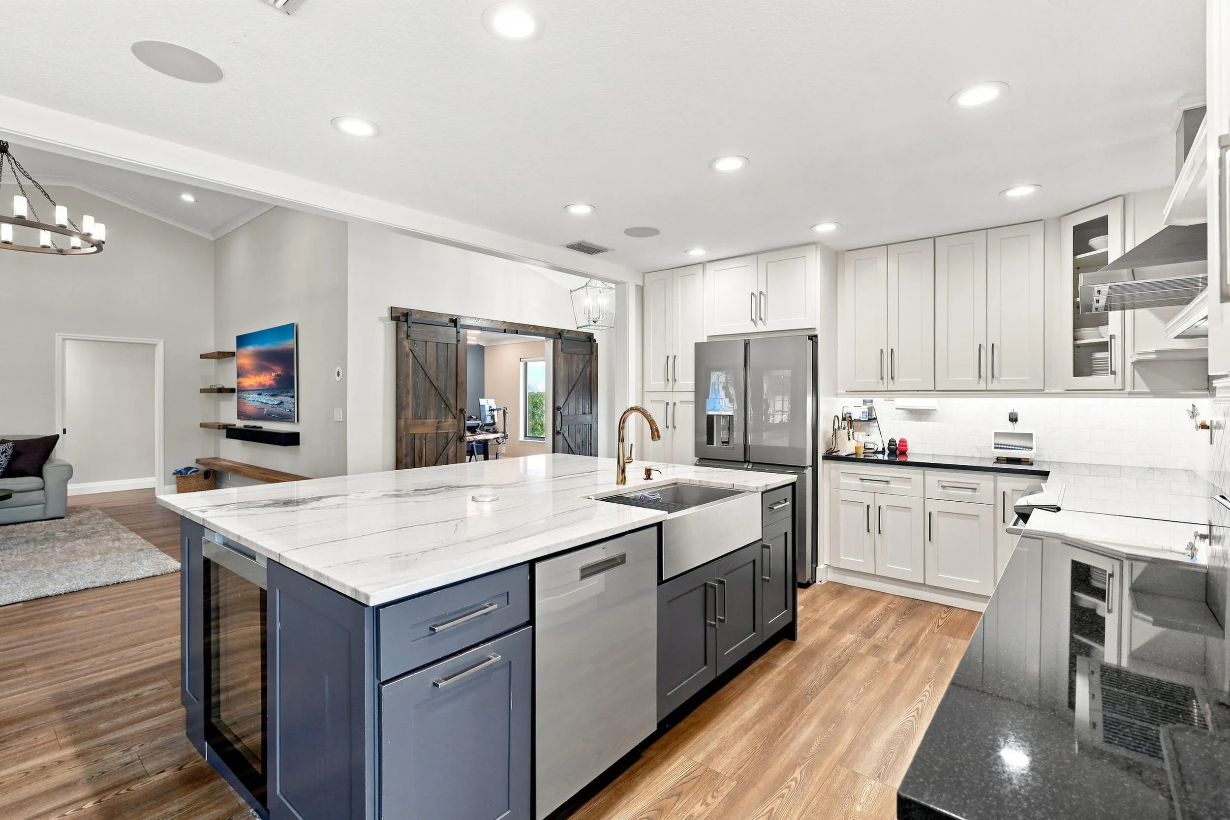 Additional kitchen view showcasing extensive cabinetry, counter space, modern appliances, and the oversized island.