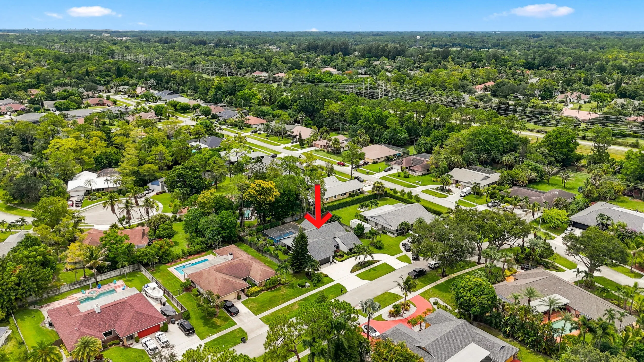 Elevated aerial view highlighting the property and surrounding Wellington neighborhood.