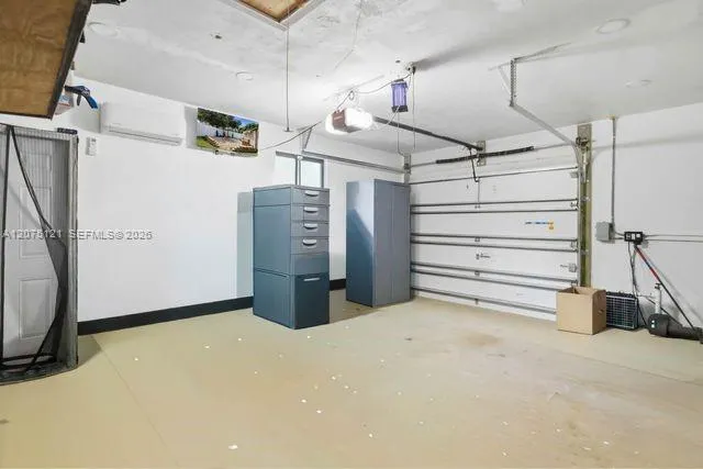 1 car garage with a split unit and a TV, perfect for a workshop.