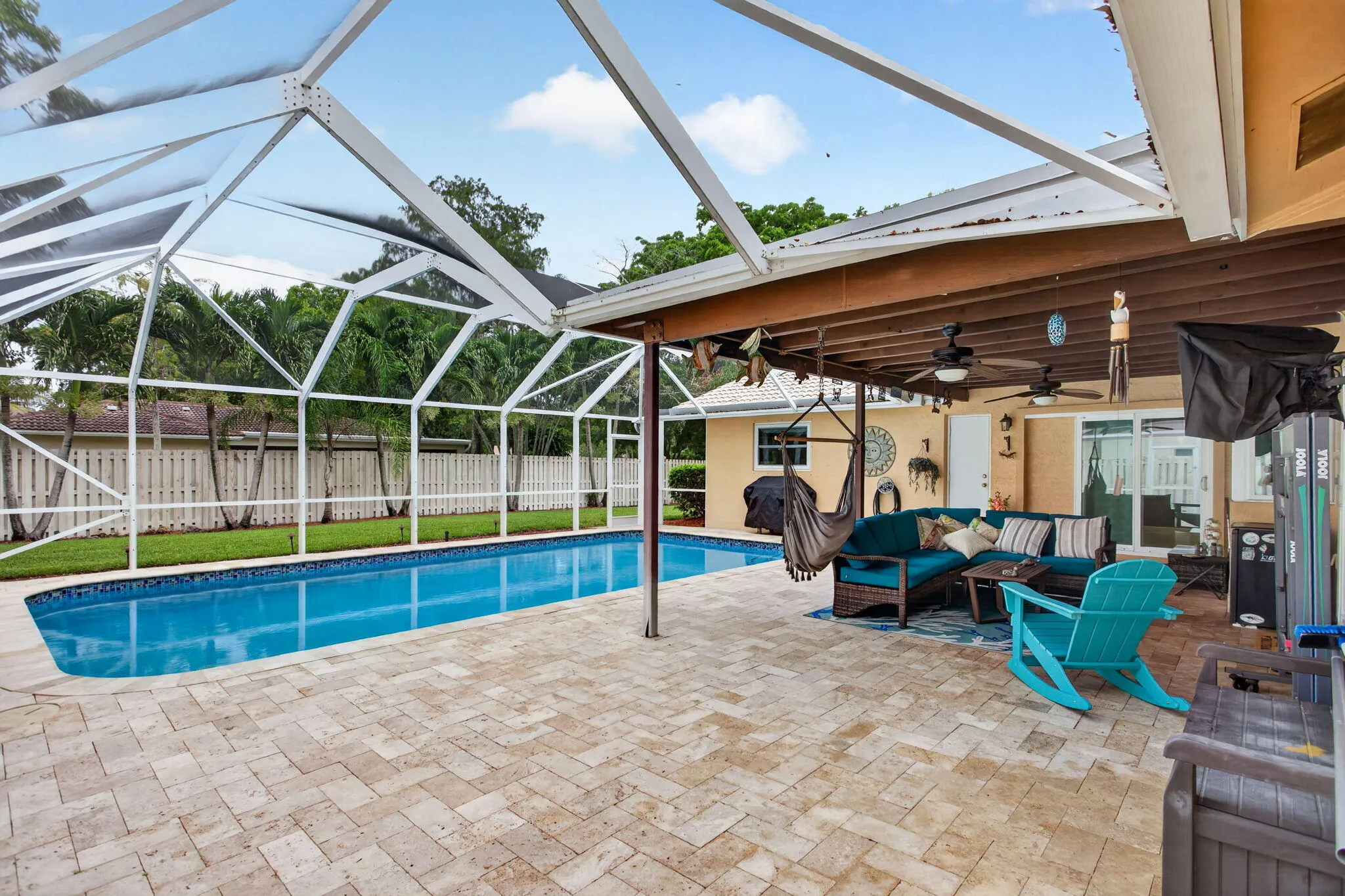 Screened-in swimming pool with a paved deck