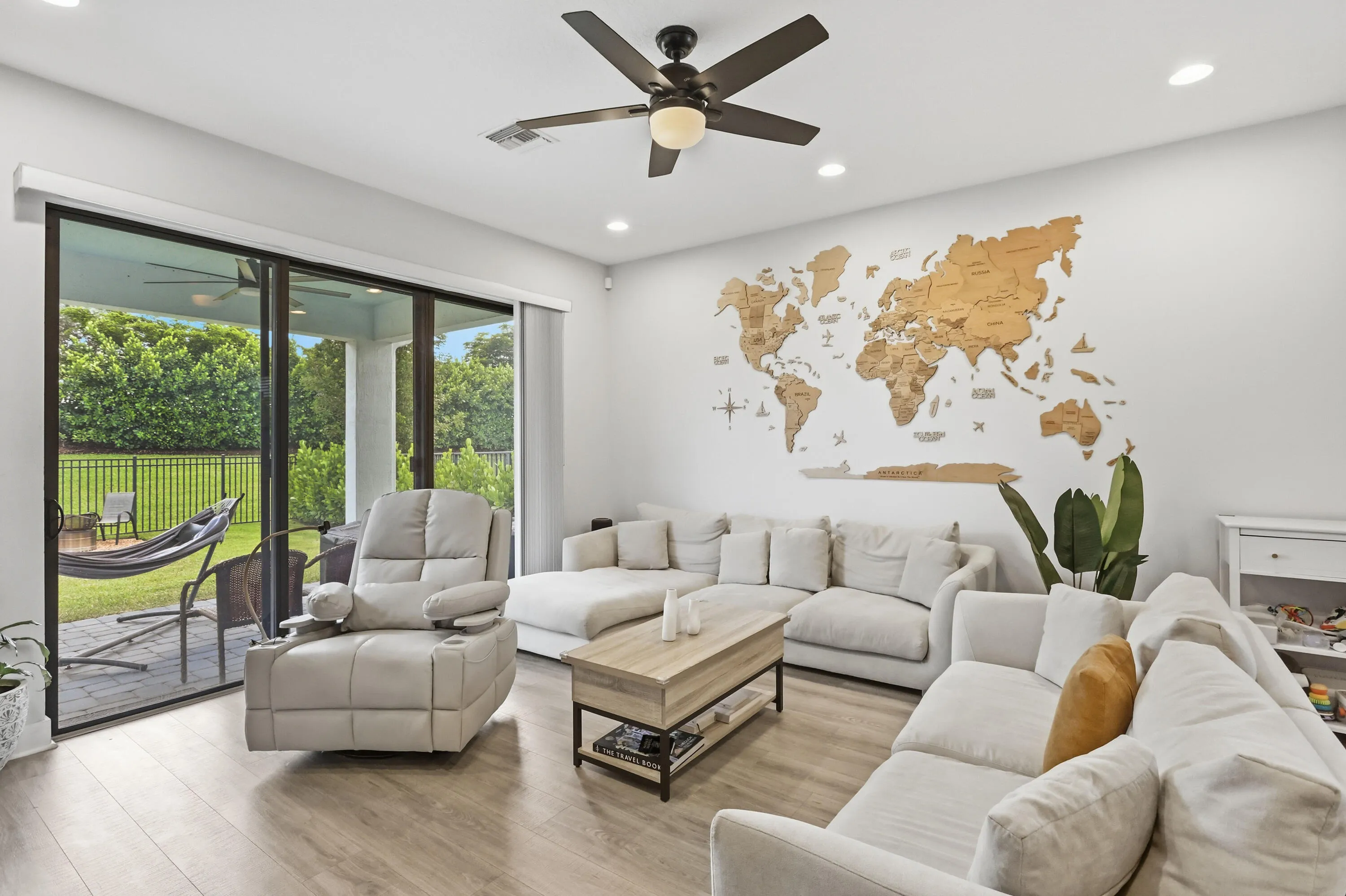 Living area featuring wood-finish flooring, recessed lighting, and a ceiling fan