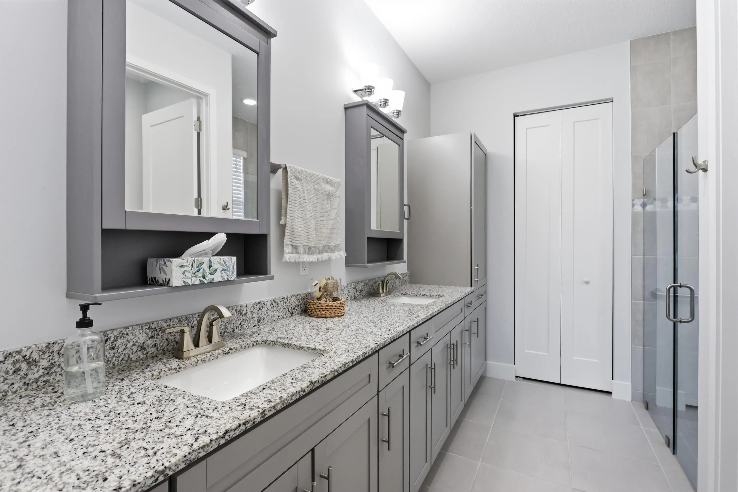 Dual vanity with stone countertops and undermount sinks