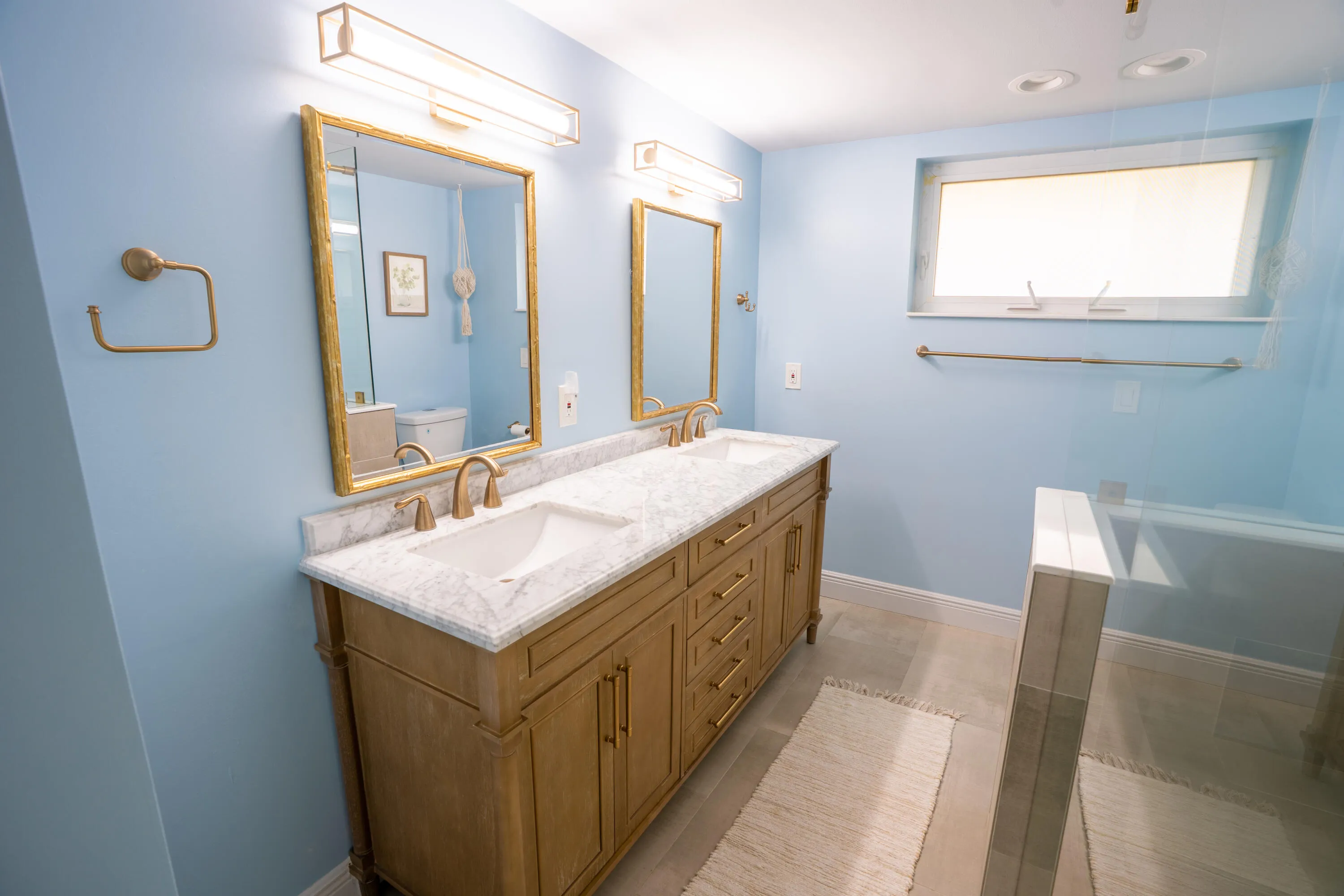 Dual vanity with white undermount sinks and light-toned countertop