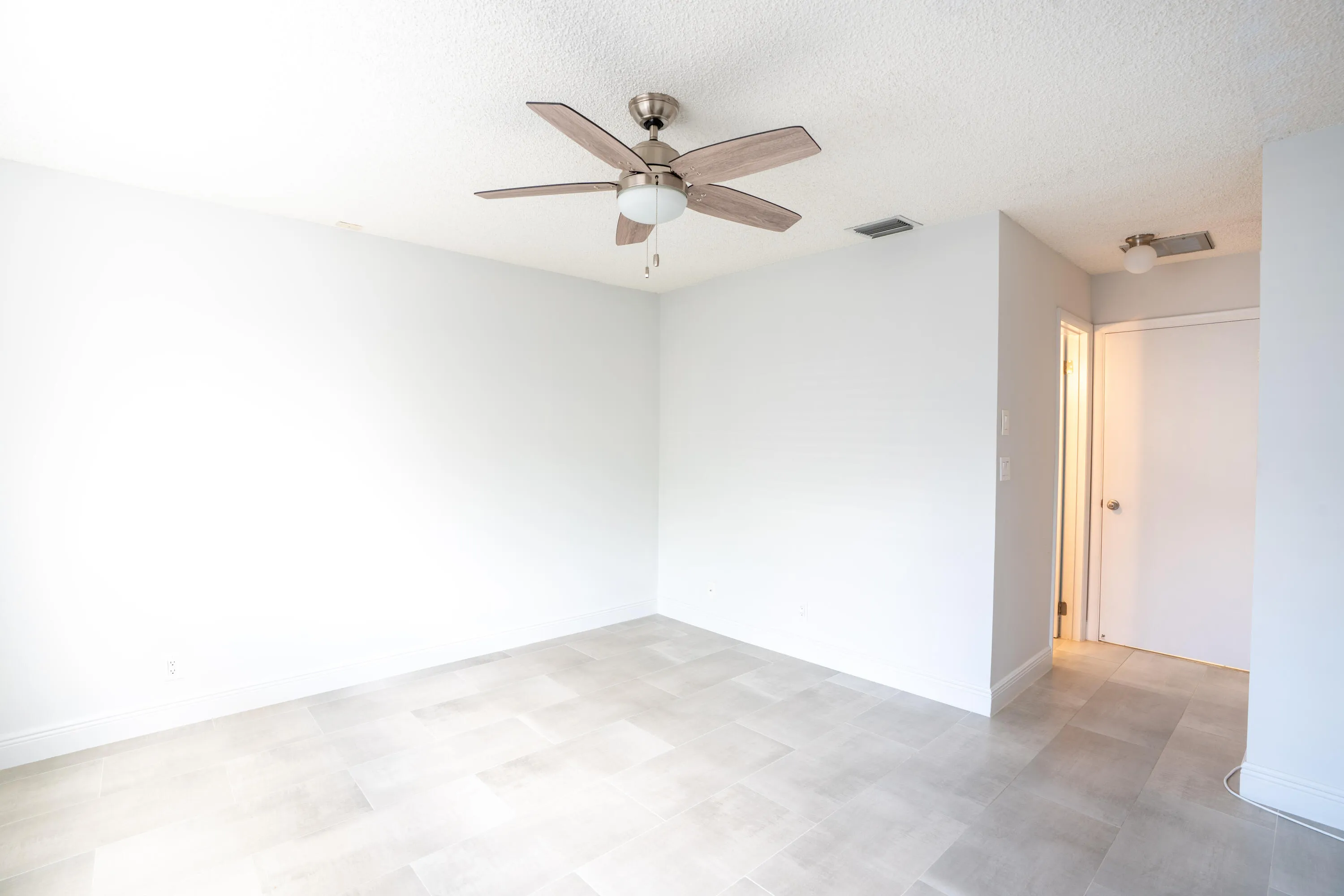 Light gray tile flooring and white walls