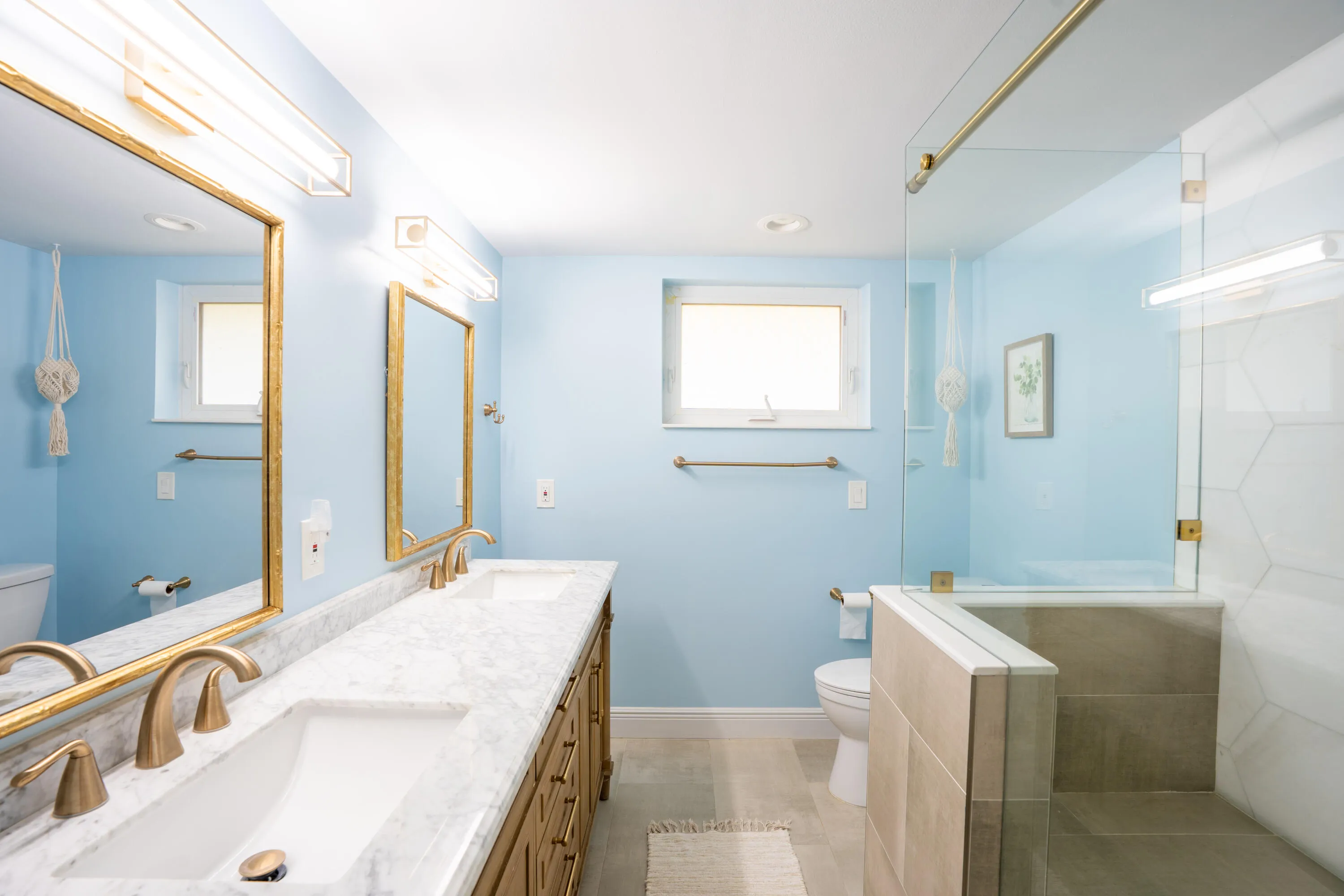Dual vanity with stone countertop and gold-finish fixtures