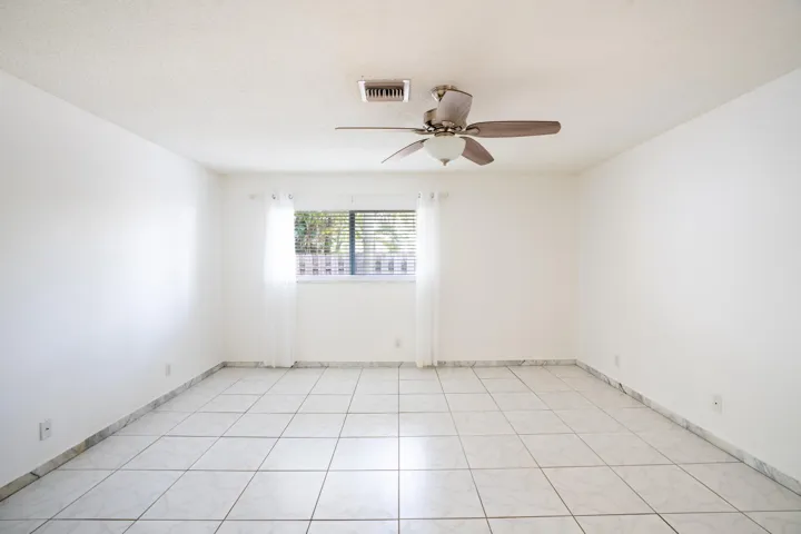 White tile flooring with coordinating base trim