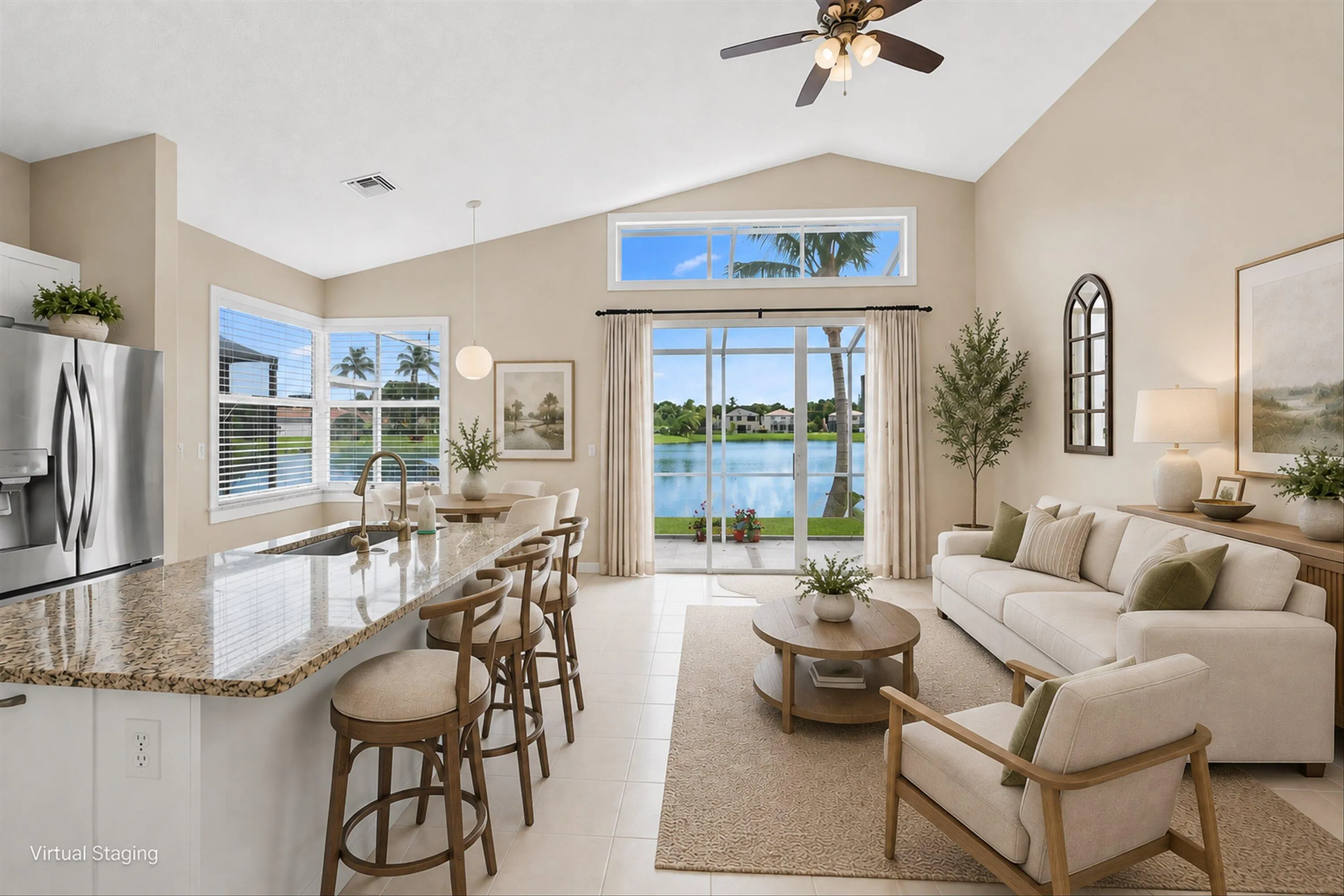 Vaulted ceiling with an integrated ceiling fan, stainless steel refrigerator, granite island countertop, sliding glass doors, and transom windows
