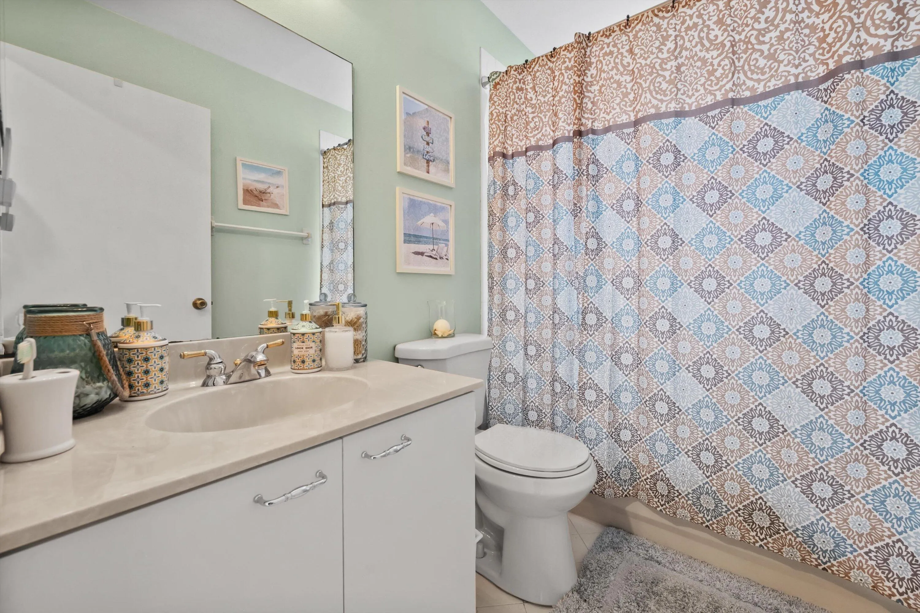 Vanity with an integrated sink, polished chrome faucet, and white cabinetry with chrome hardware