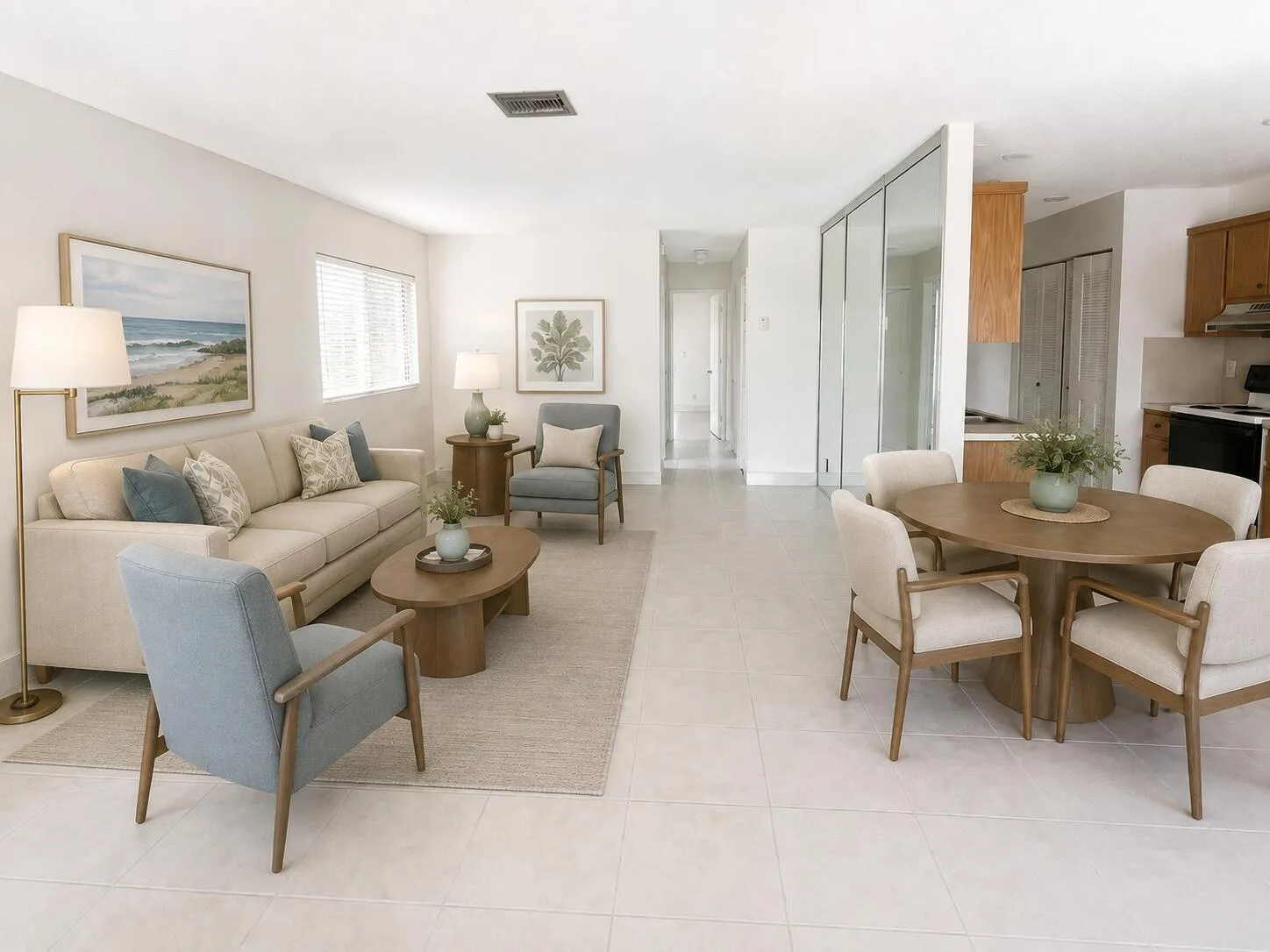 Open-concept living area featuring light-toned flooring