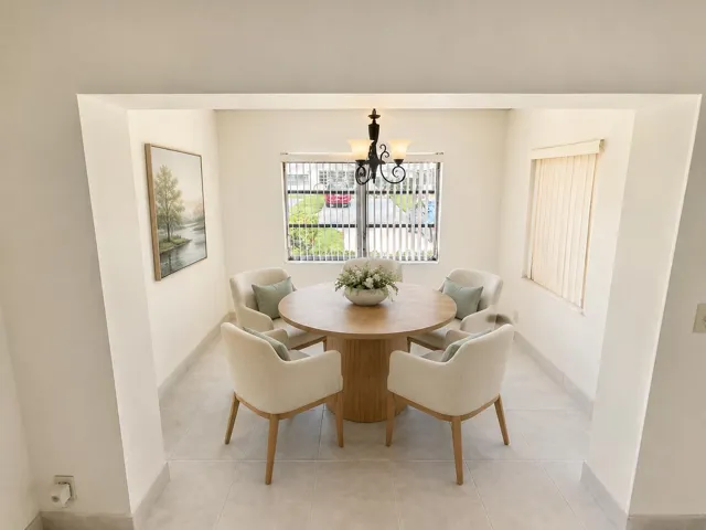 Recessed dining area featuring tile flooring, a window with vertical blinds, and a built-in light fixture