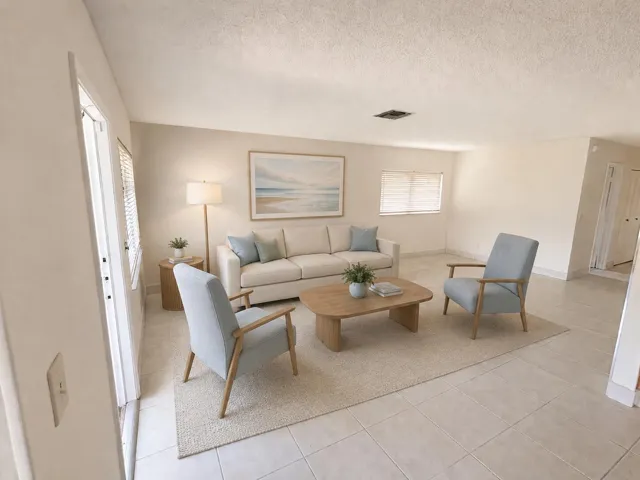 Neutral tone wall paint, tile flooring, and textured ceiling